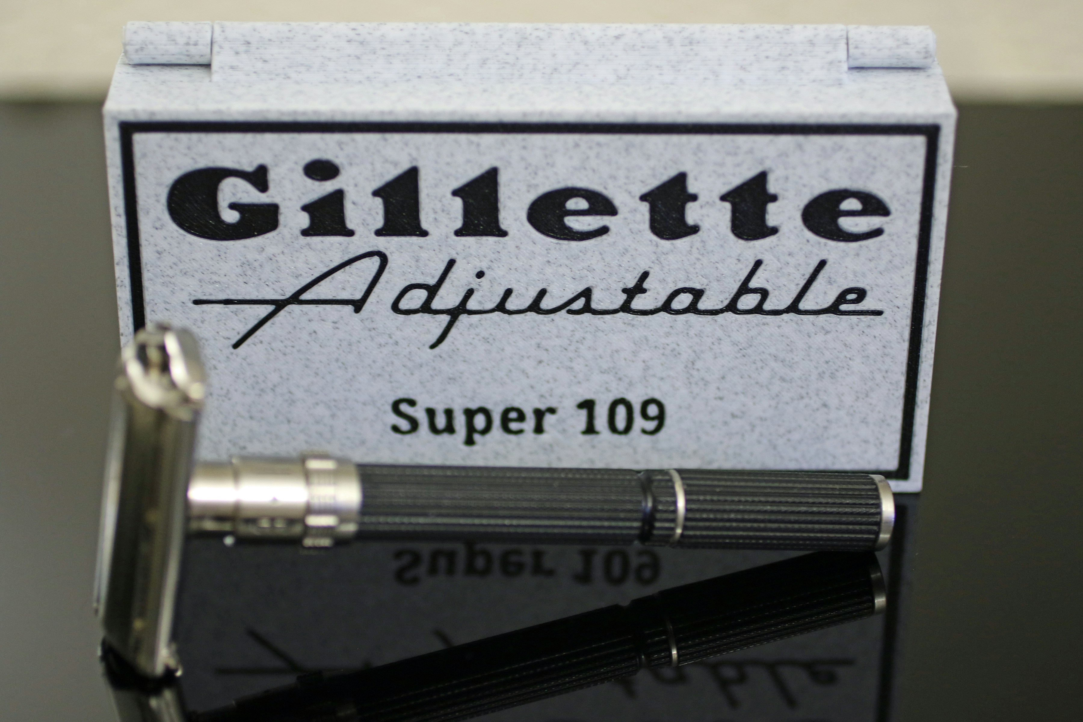 A gillette adjustable super 109 razor with its case.