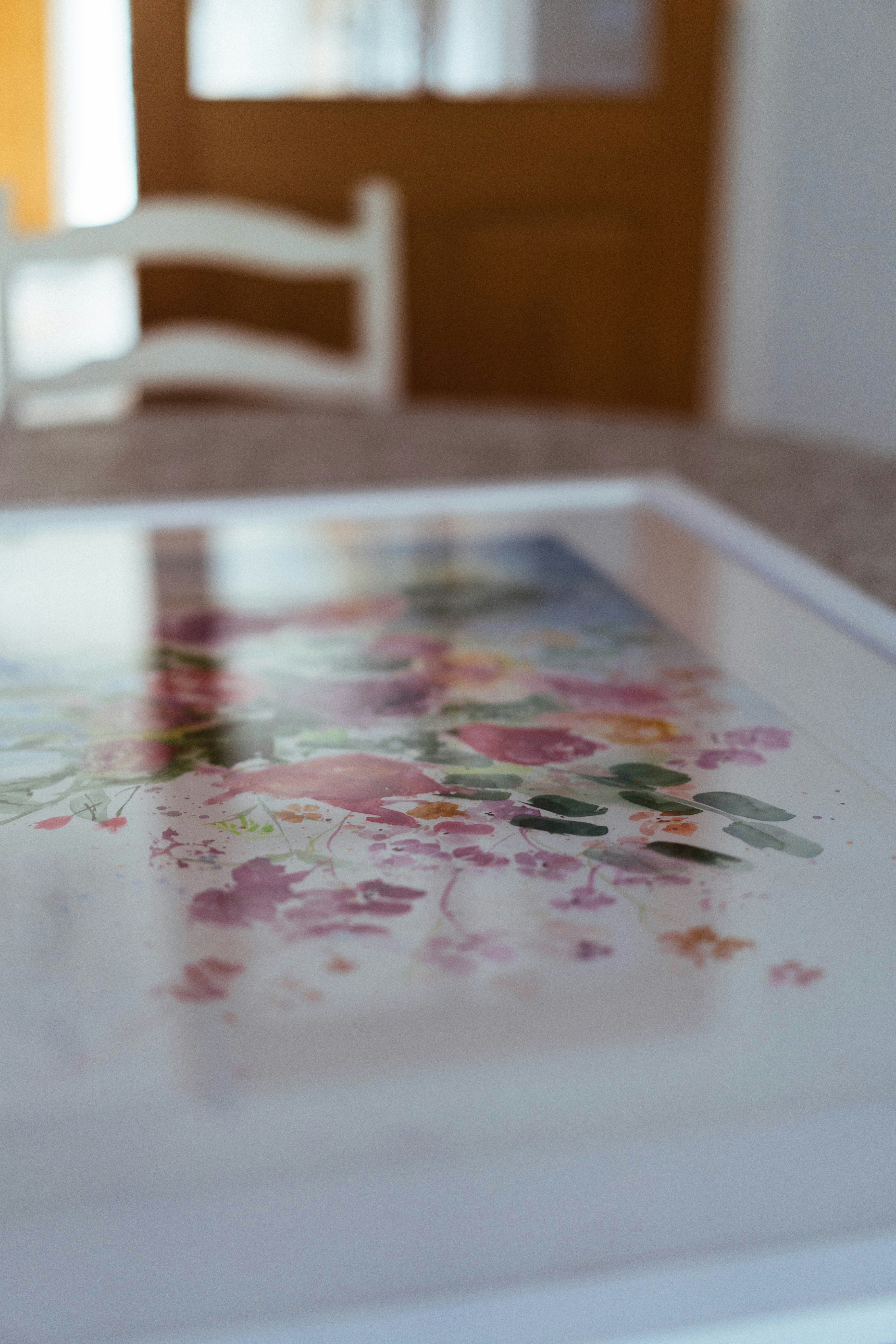 A framed watercolor painting of colorful flowers.