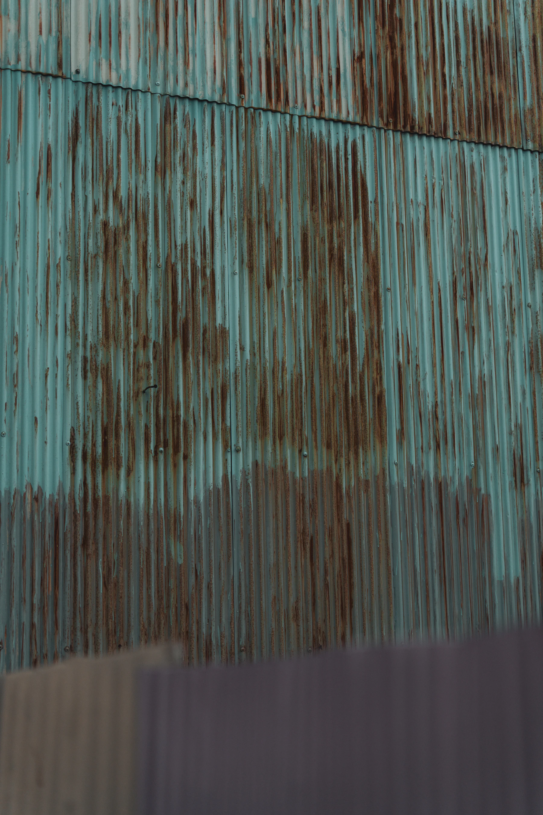 Ribbed copper roofing, half still bright and half turned green with patina