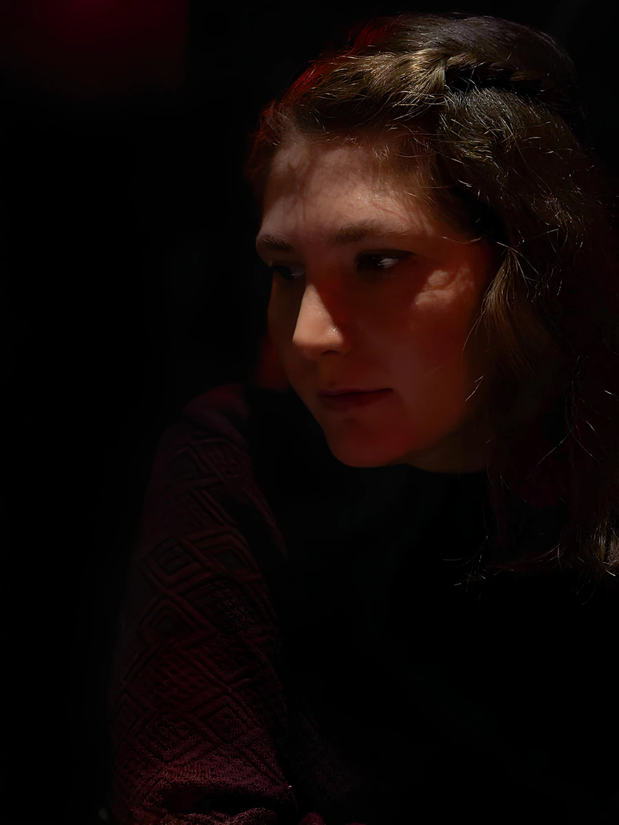 A young woman with braided hair in red light