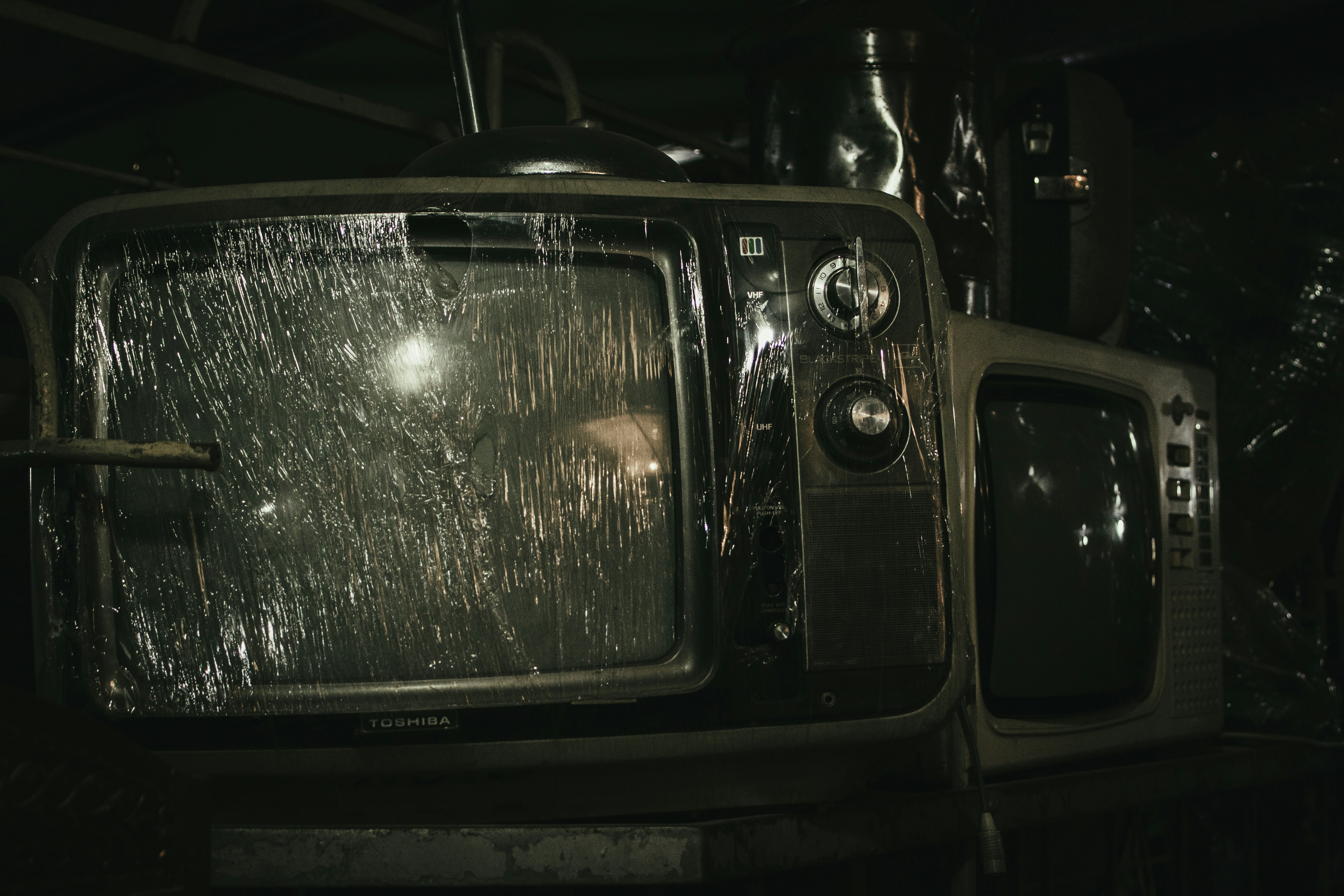 An old, broken television set with a shattered screen.