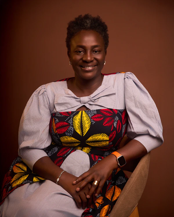 Smiling woman in a vibrant patterned dress