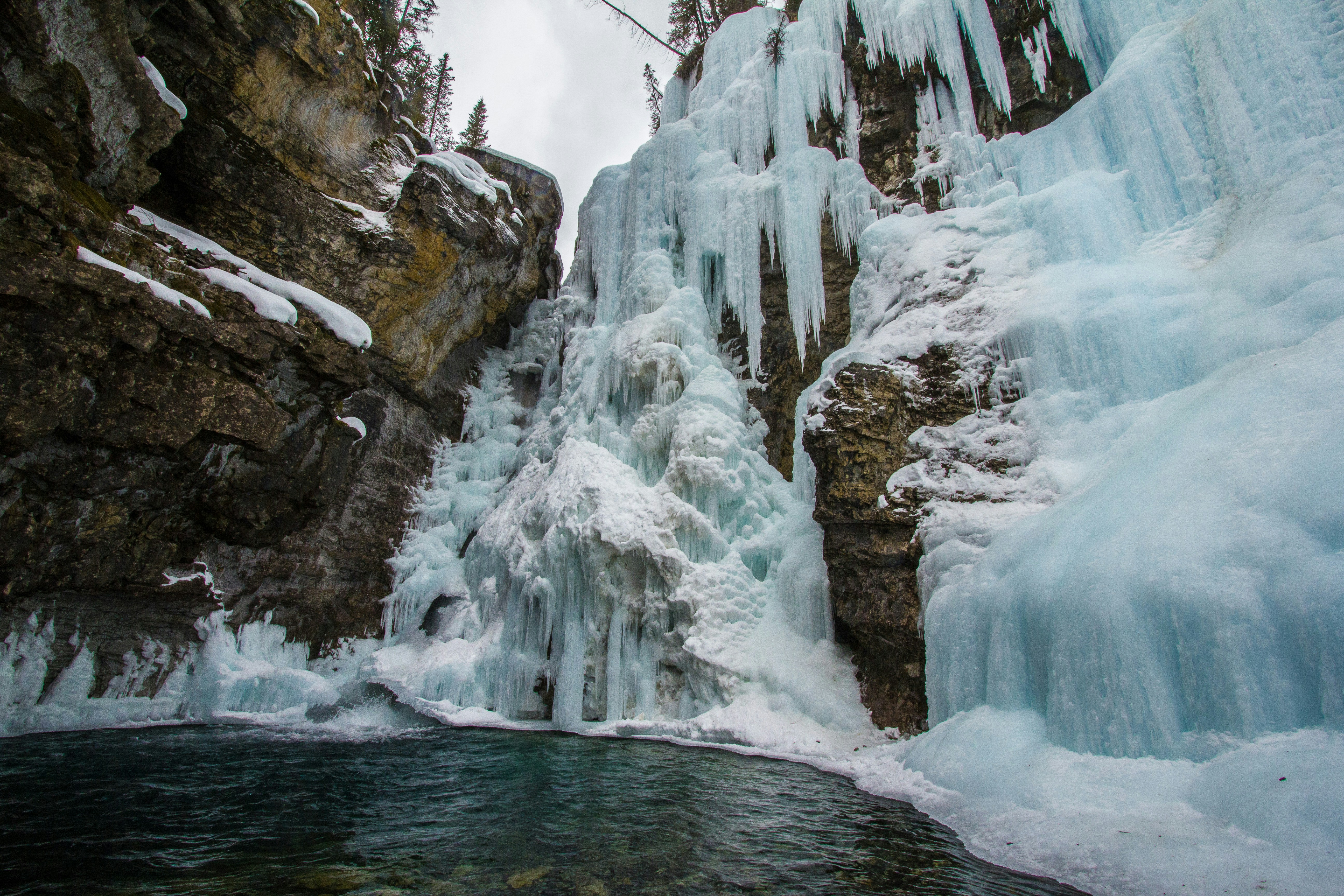 Stunning frozen waterfall and ice formations in a winter canyon.