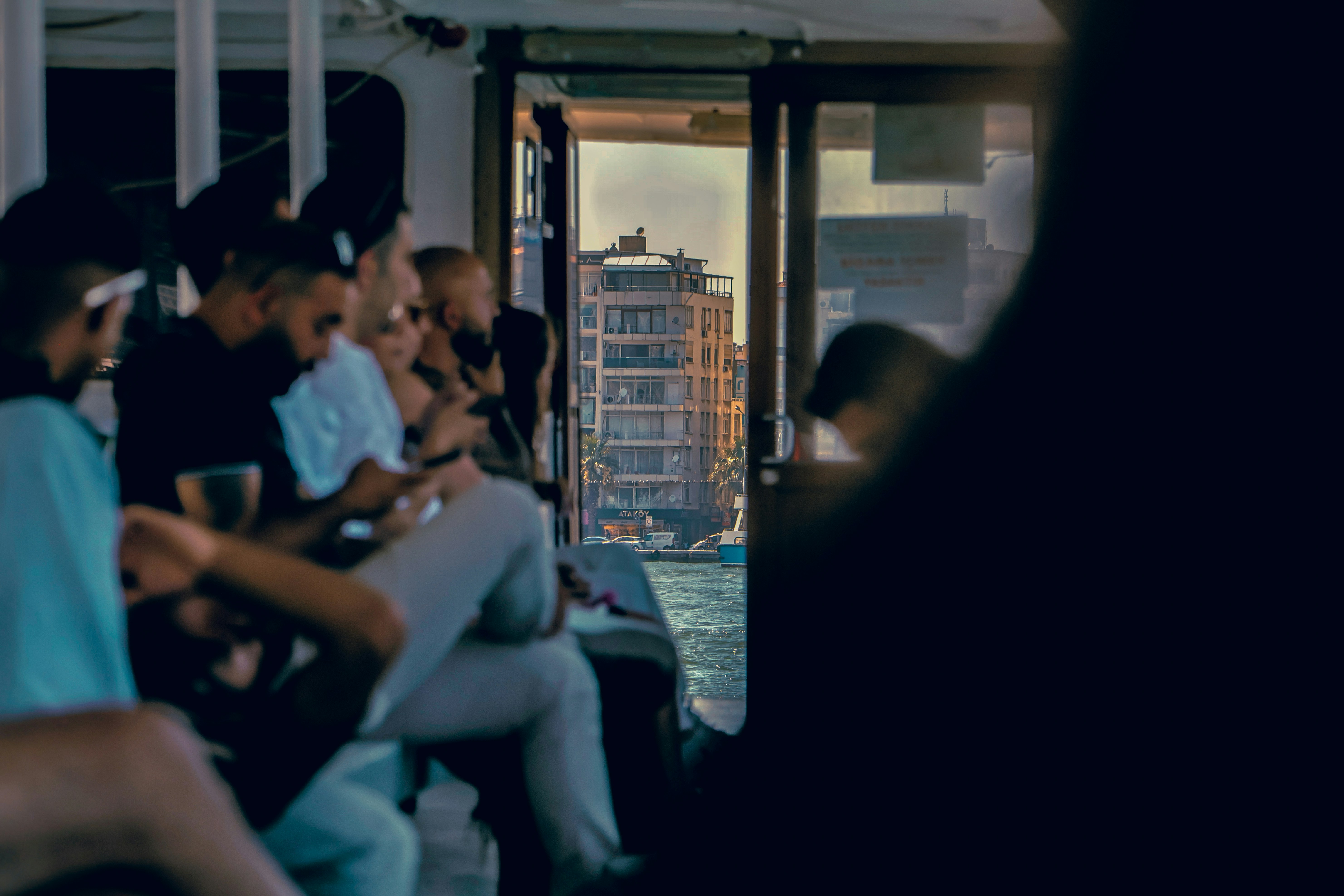 People on a boat viewing a city building and water