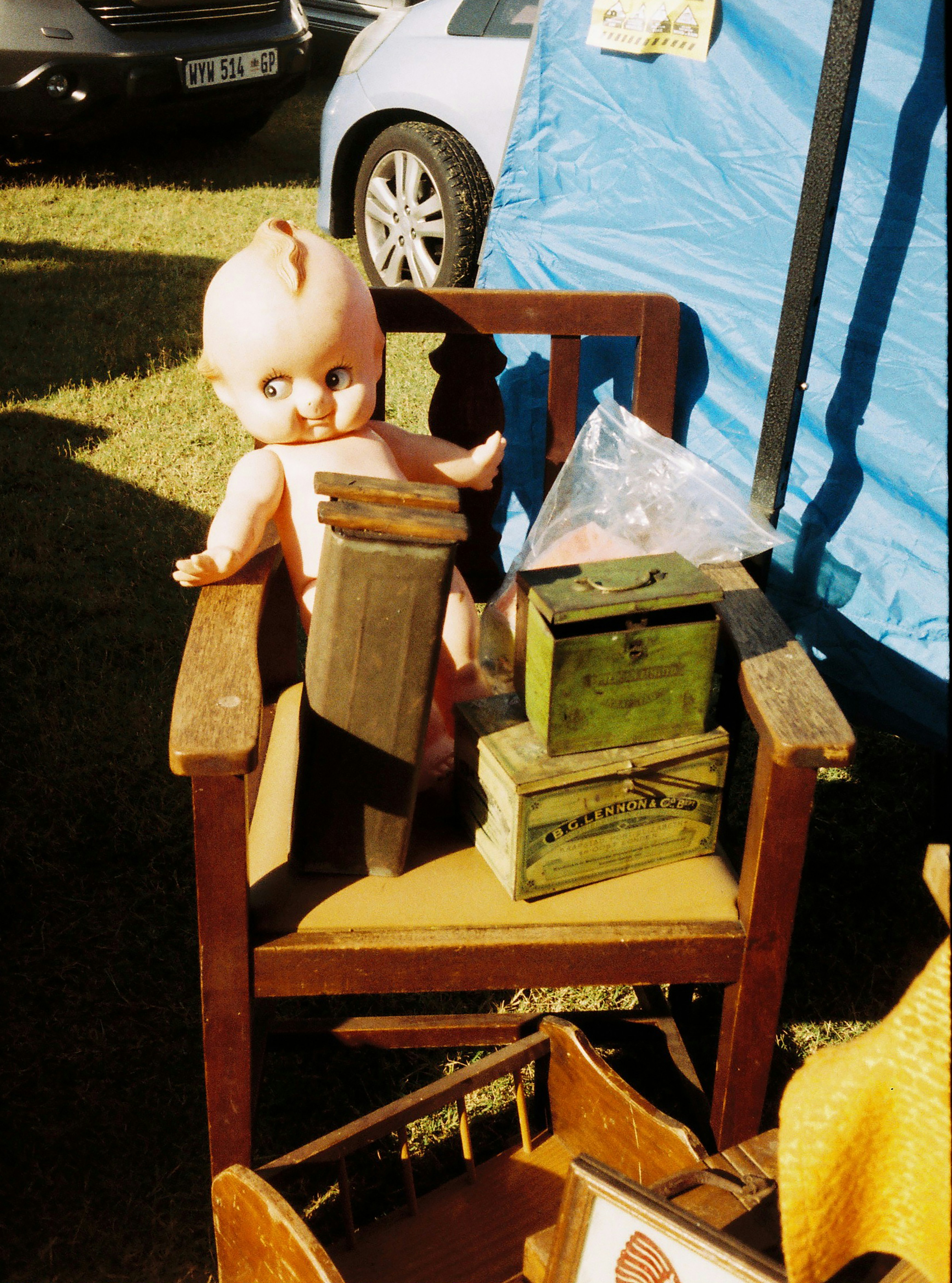 Vintage baby doll and boxes on wooden chair