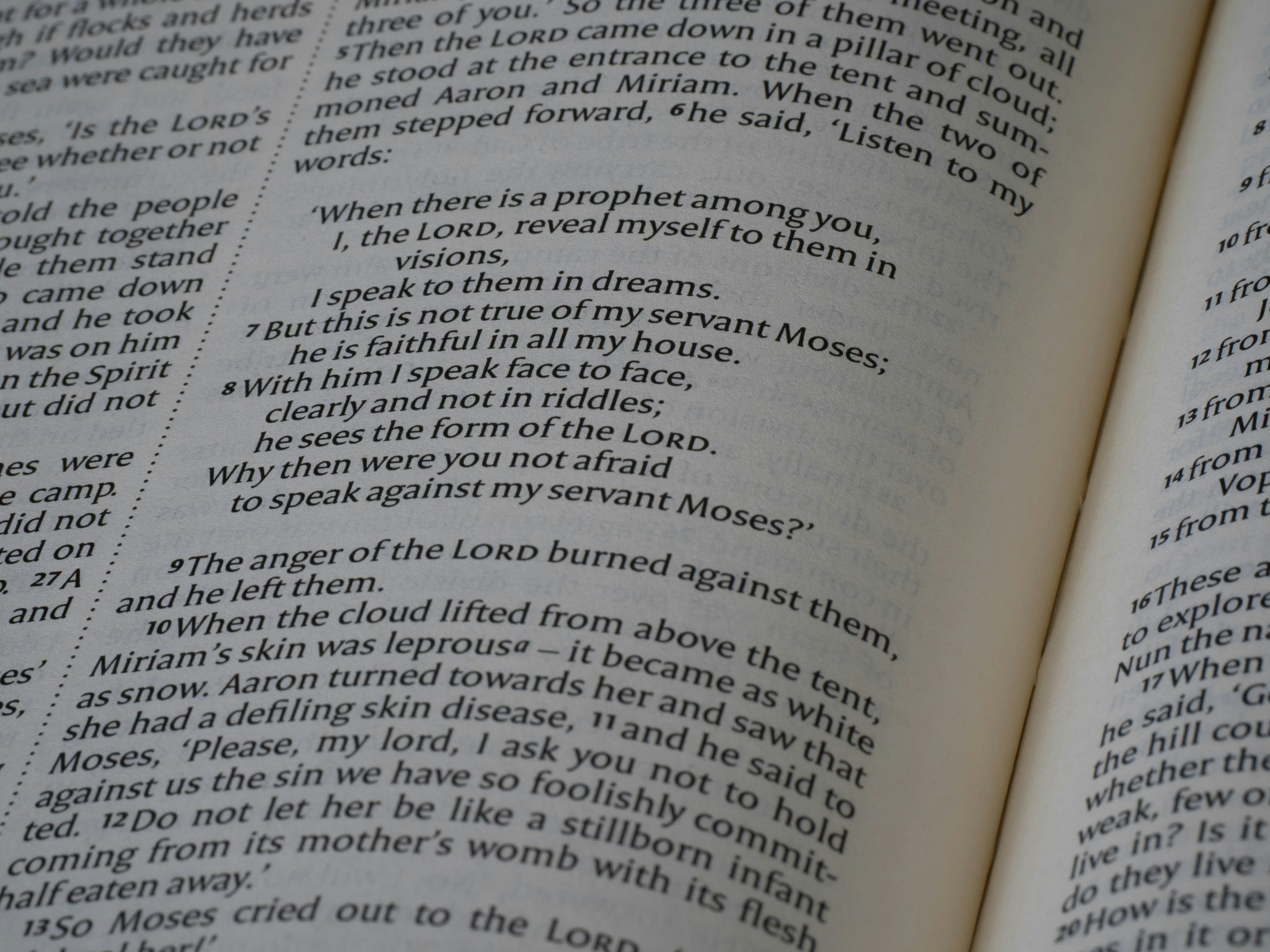 An open bible displaying text on its pages.