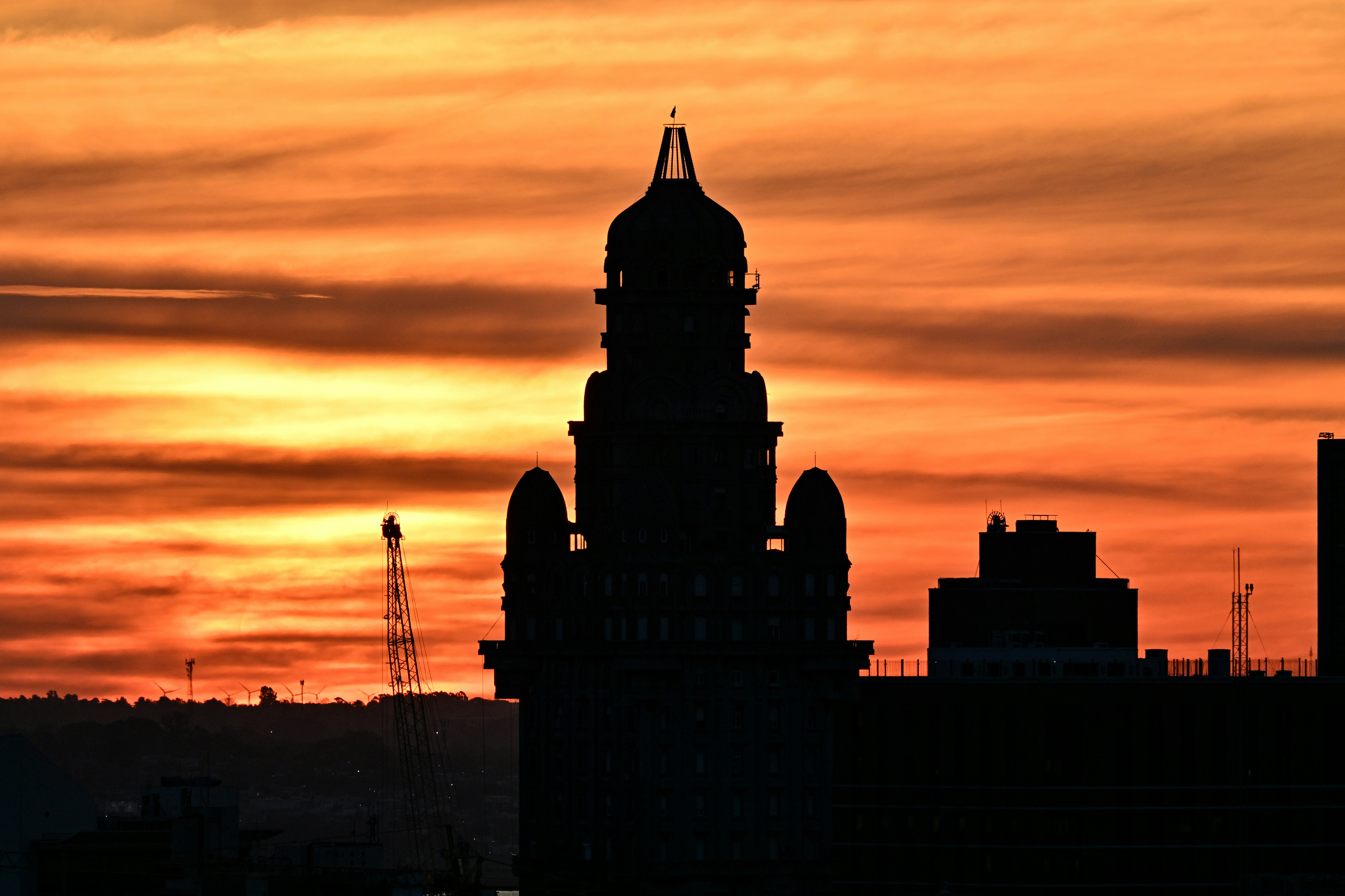 Silhouette eines Gebäudes vor einem leuchtend orangefarbenen Sonnenuntergangshimmel