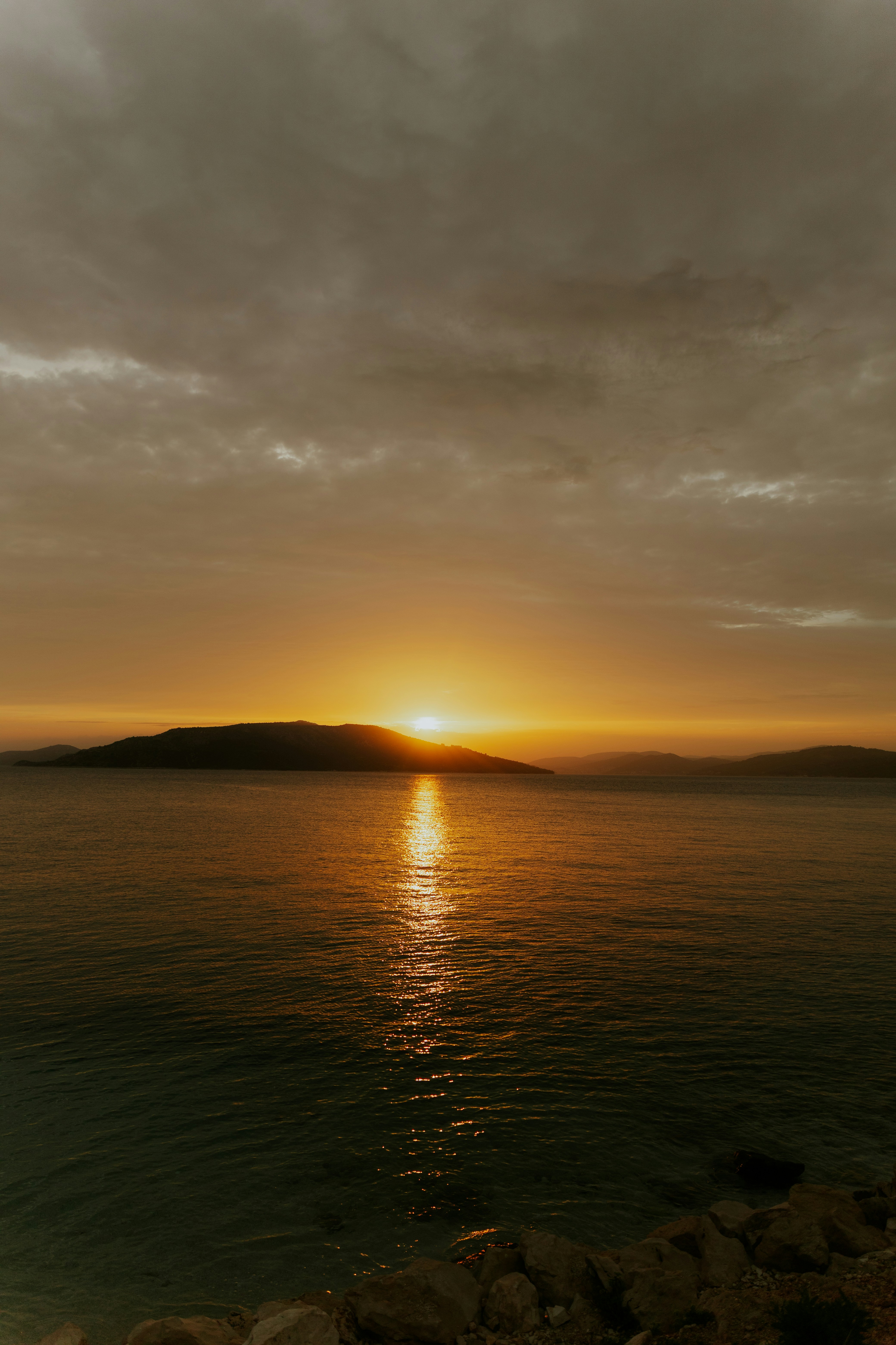 Golden sunset over the ocean with a distant island