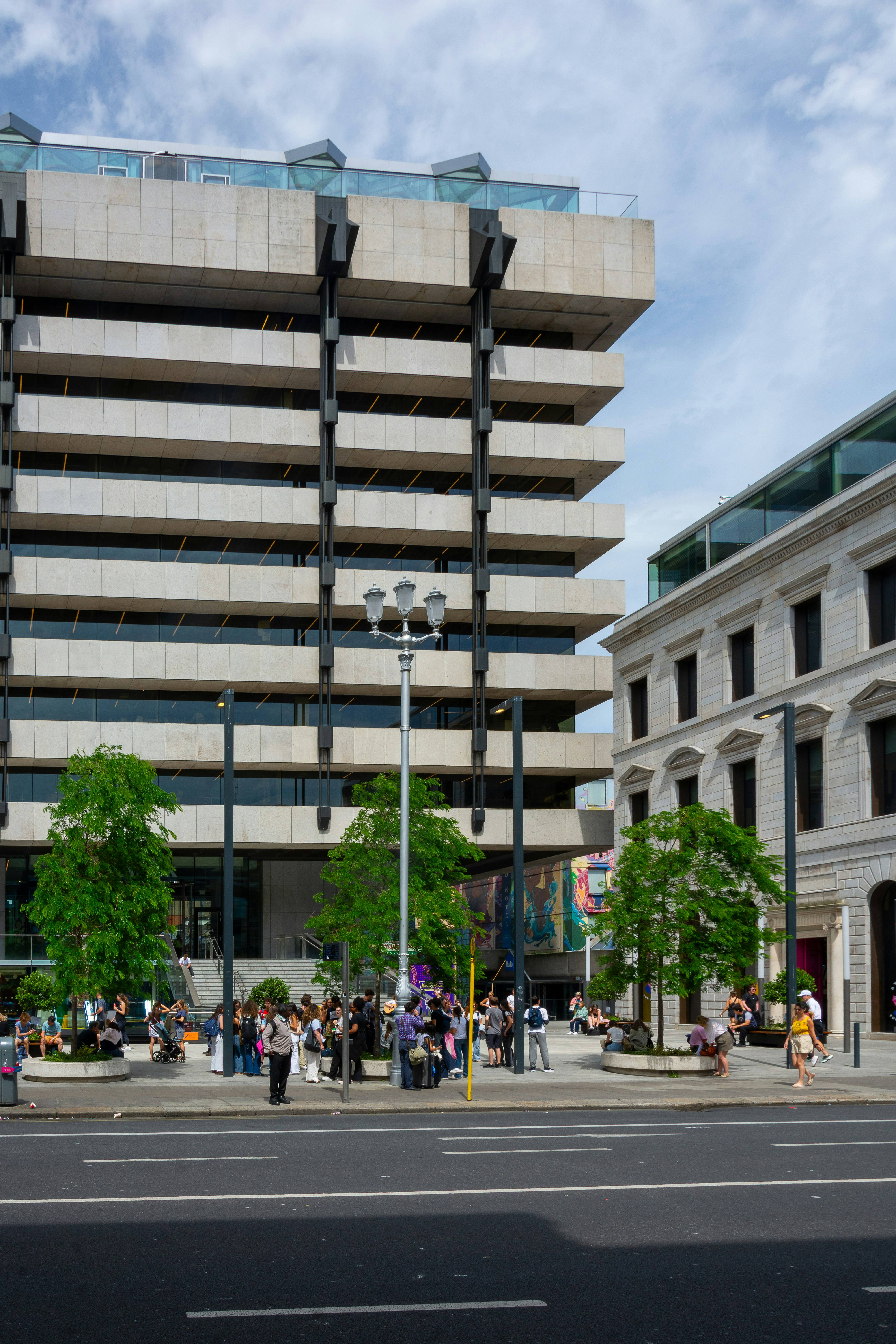Modern and traditional buildings with people on a city street.