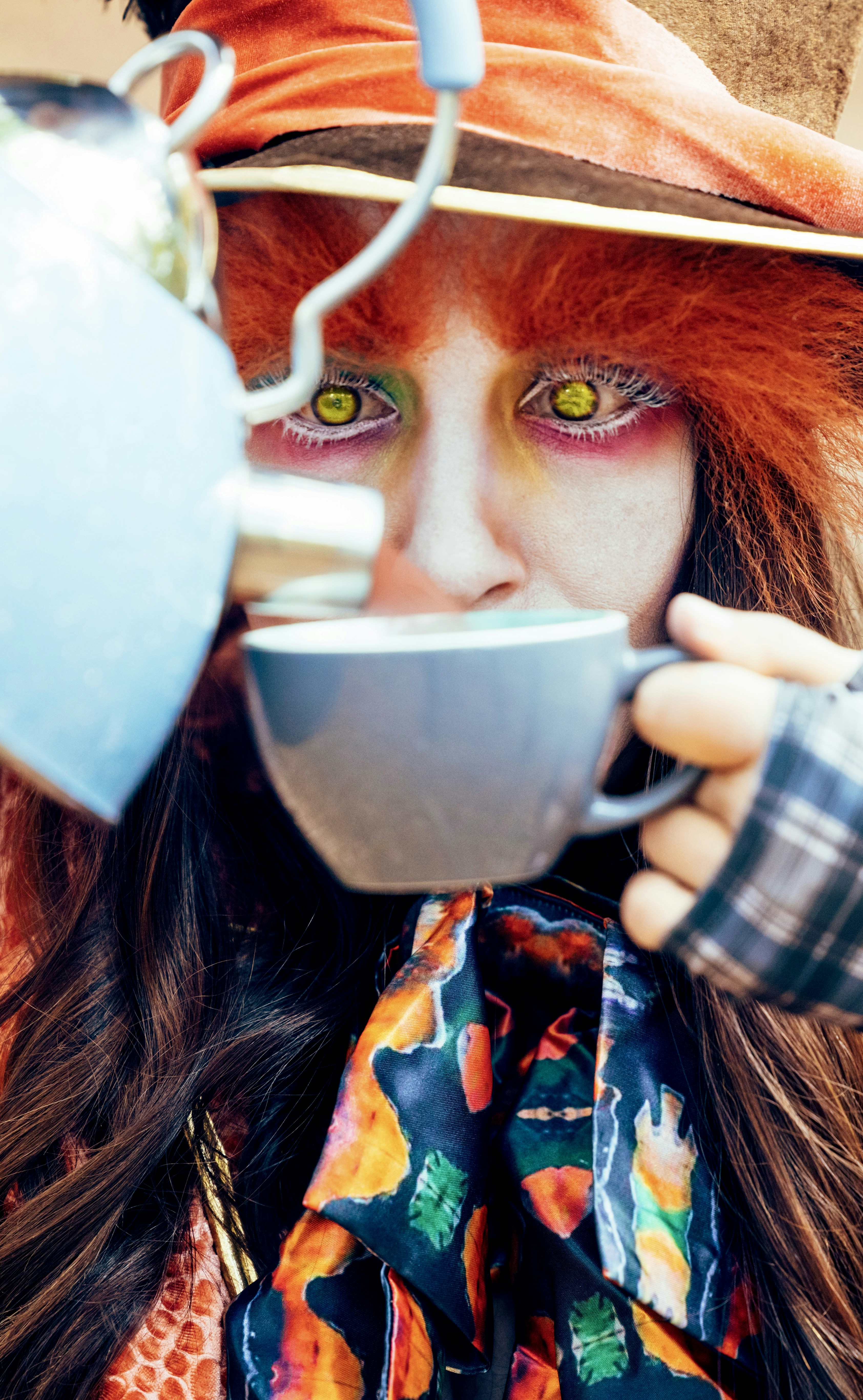 Mad hatter character pouring tea into a cup.