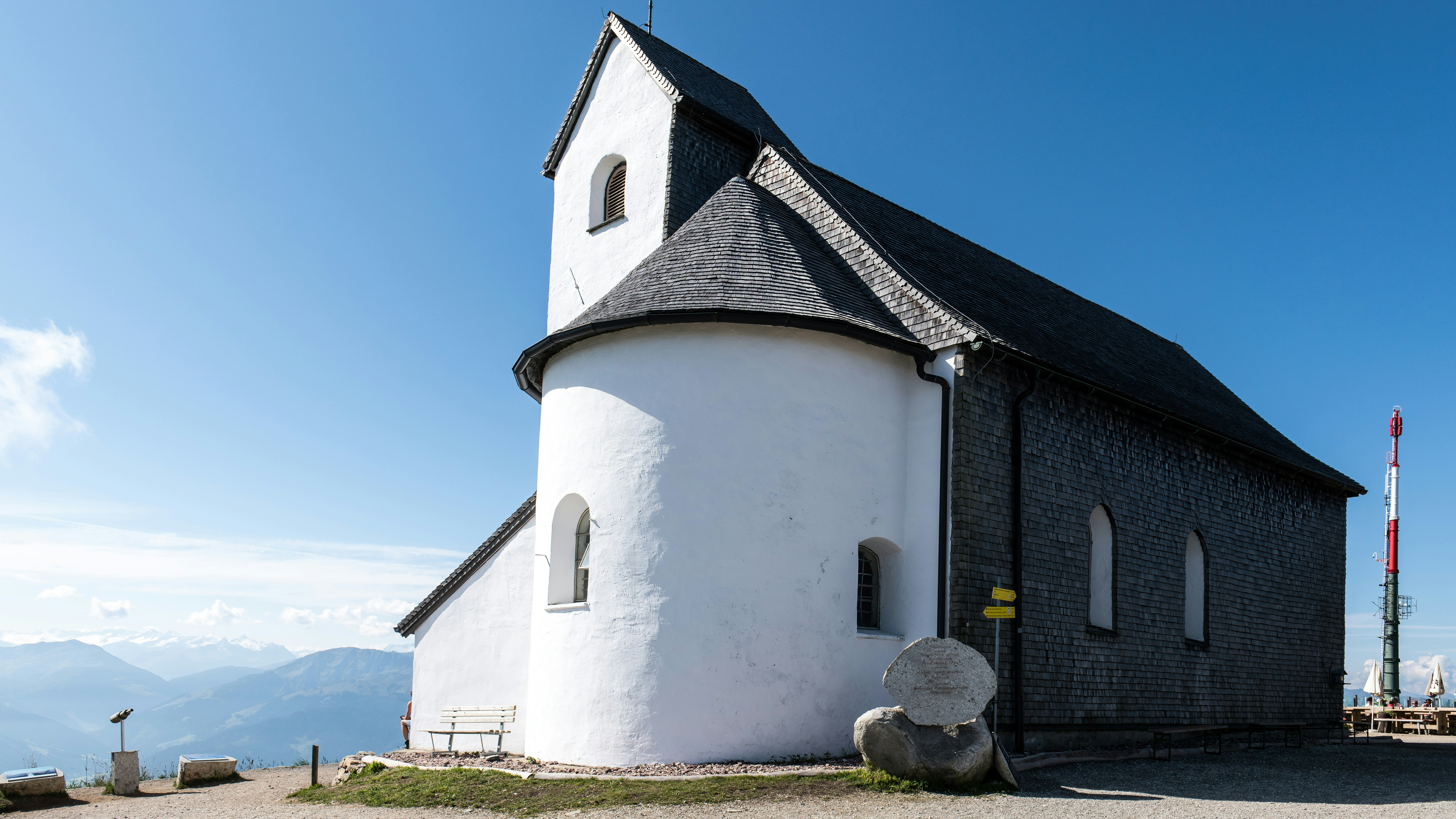 White church with a steeple on a mountain.