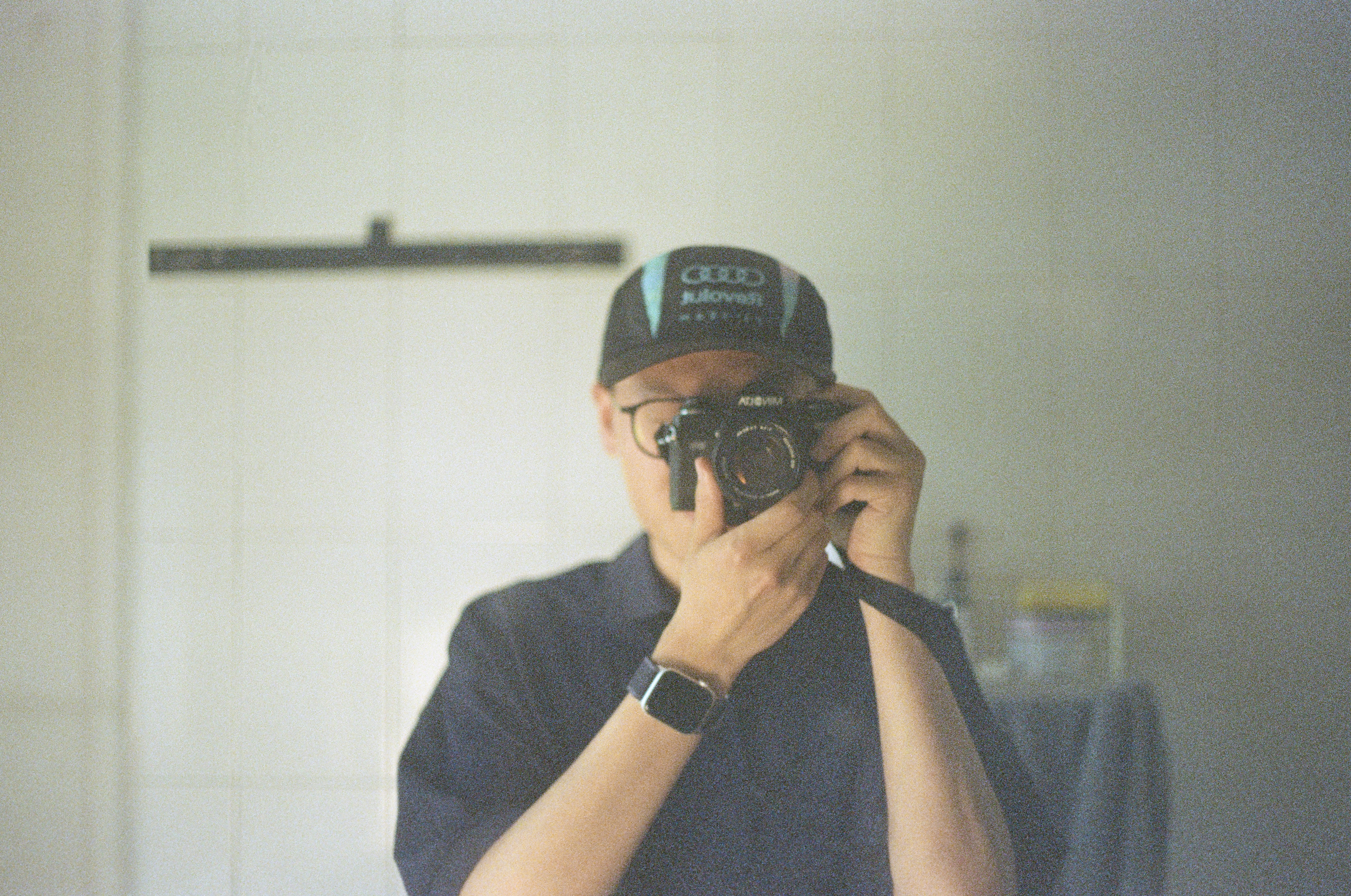 Person taking a mirror selfie with a camera.