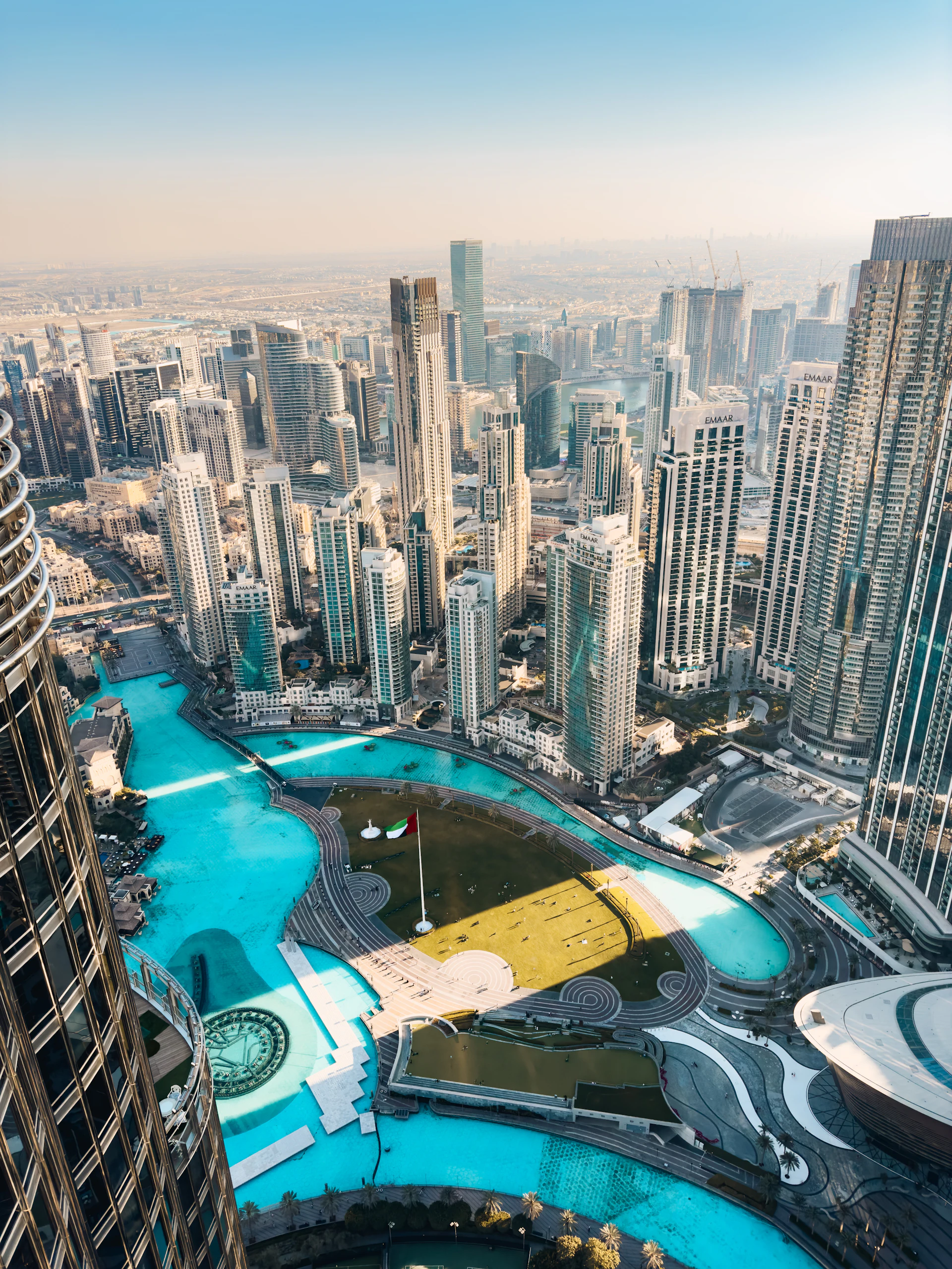 Aerial view of the Dubai cityscape with skyscrapers and turquoise water