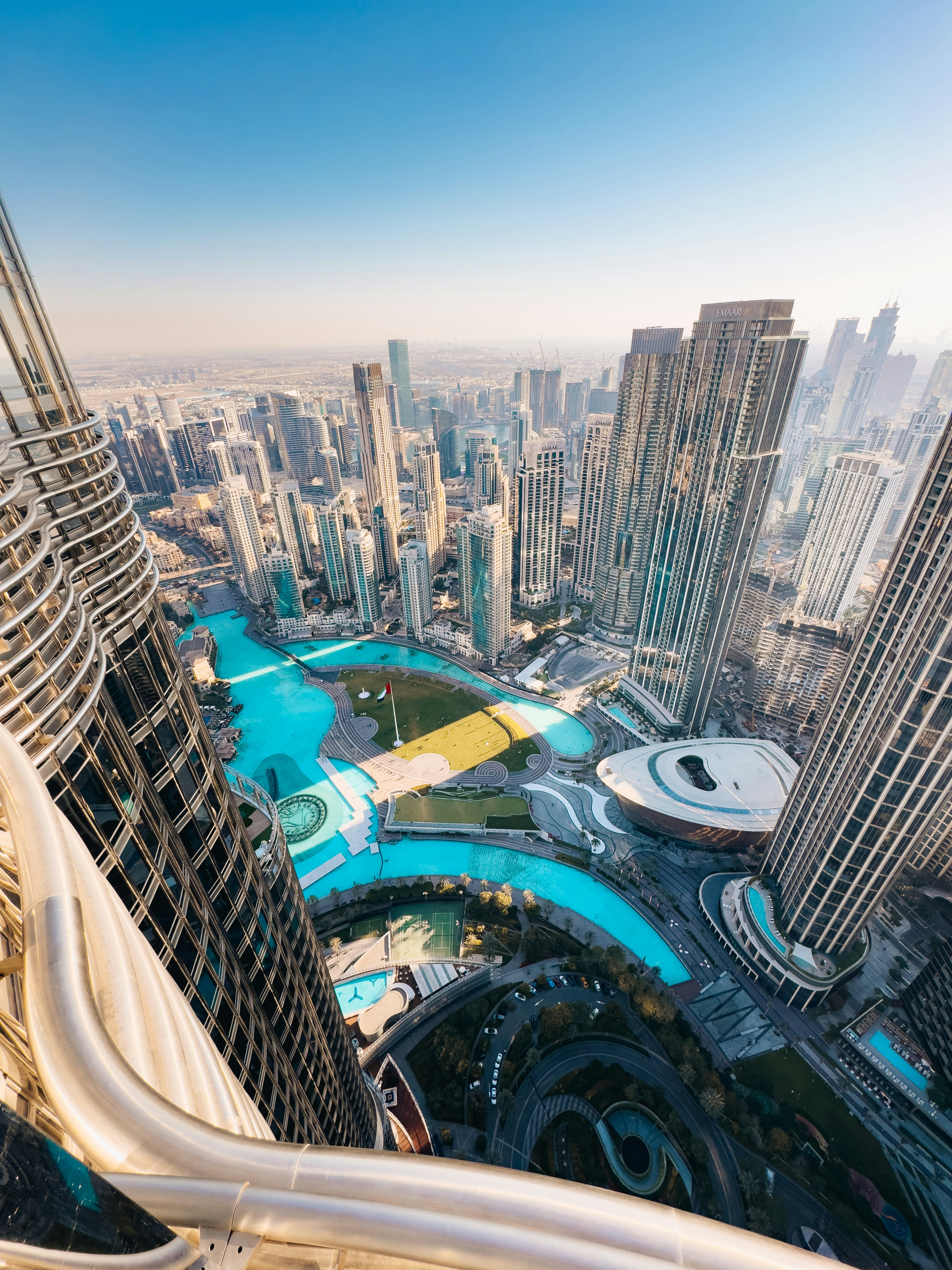 Modern city with towering skyscrapers and a winding blue canal