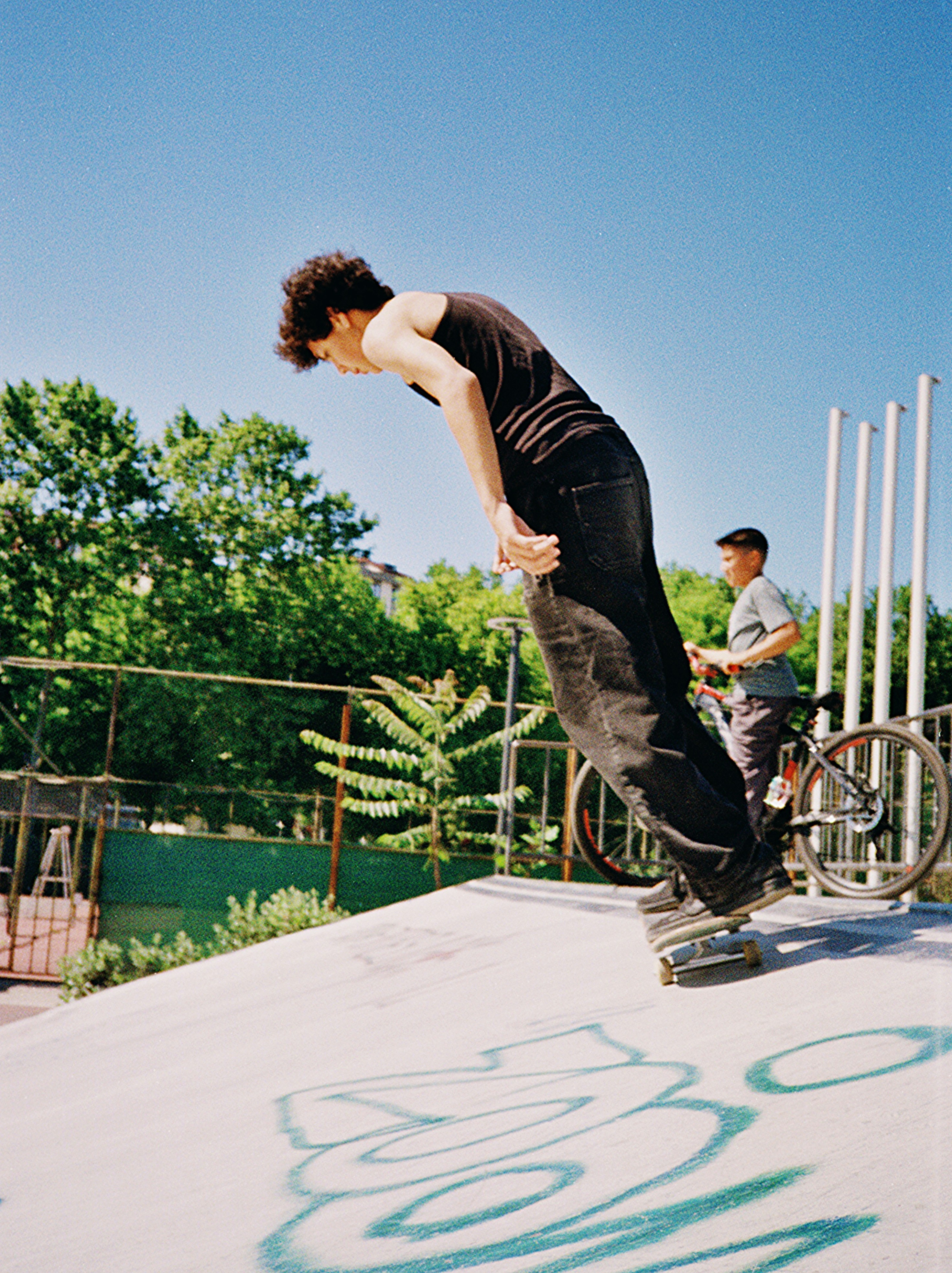 Skateboarder performing a trick on a ramp.