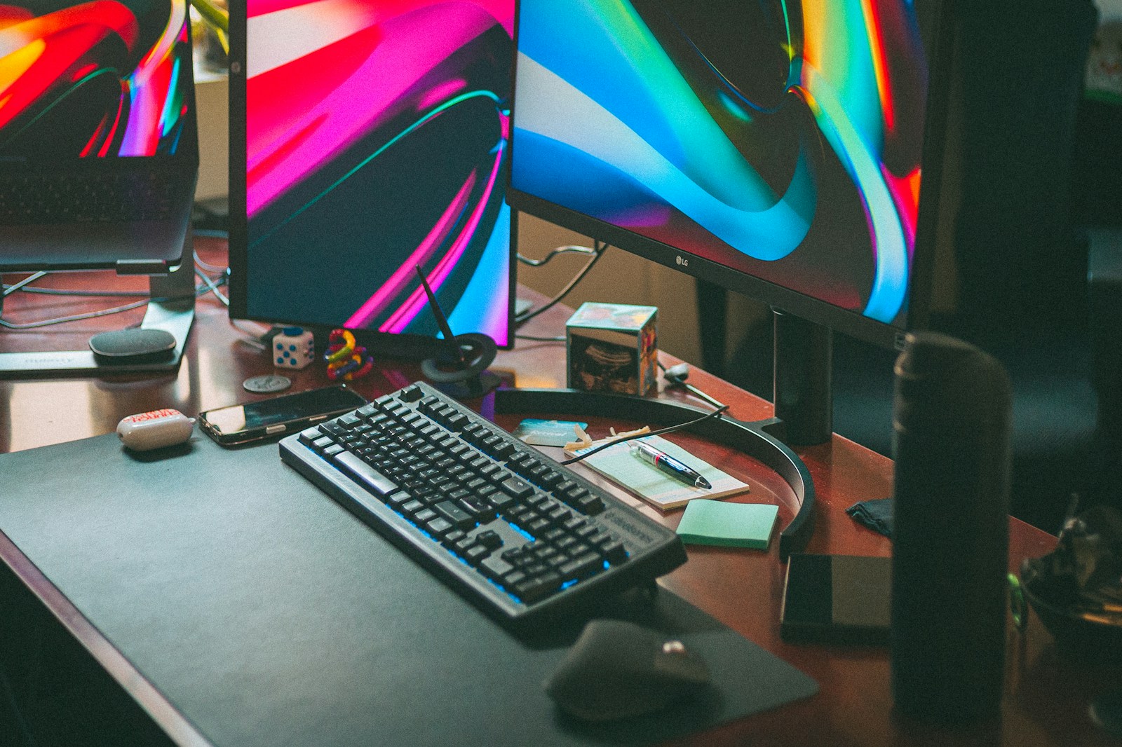 Two computer monitors on a wooden desk