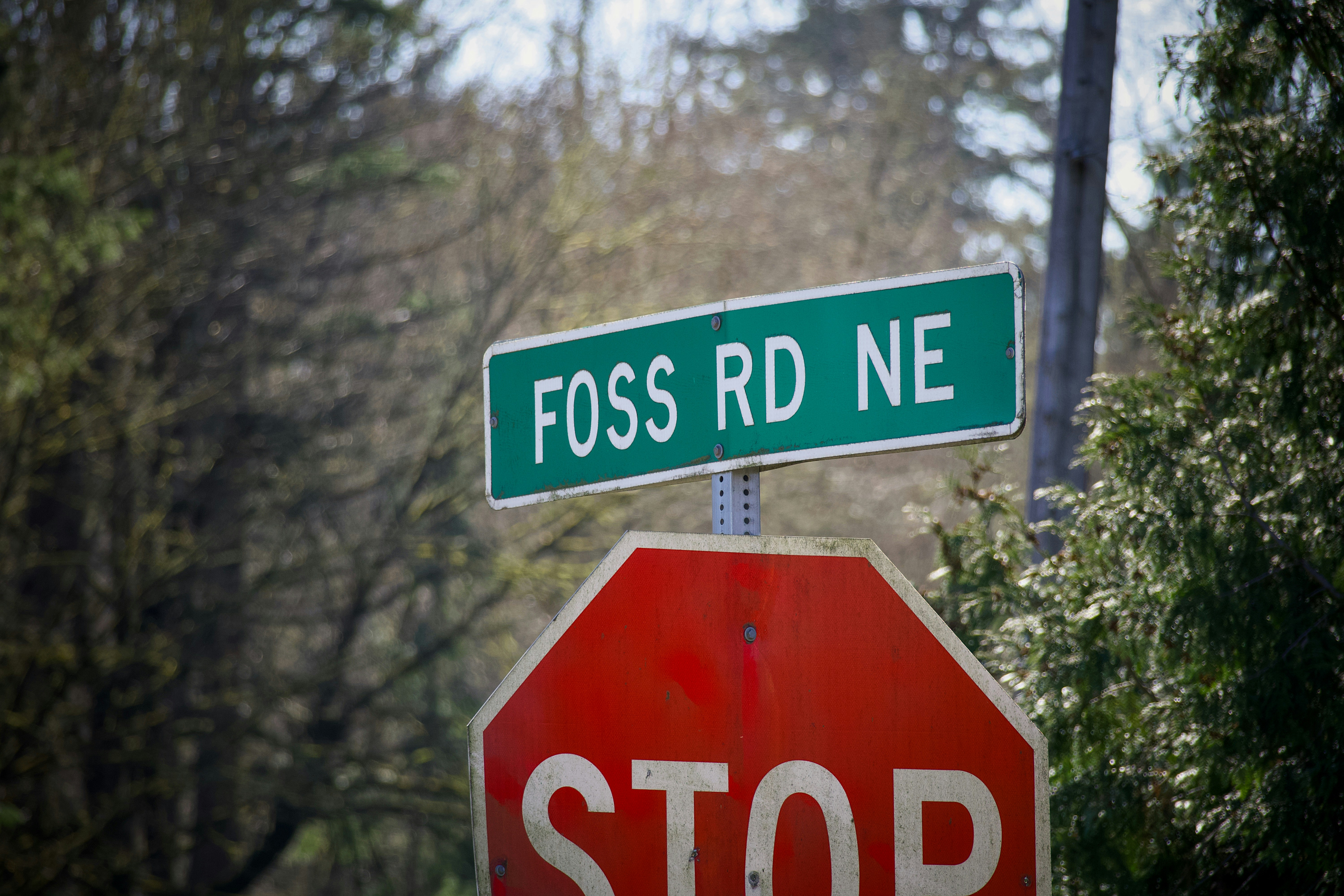 Foss rd ne street sign and a red stop sign.