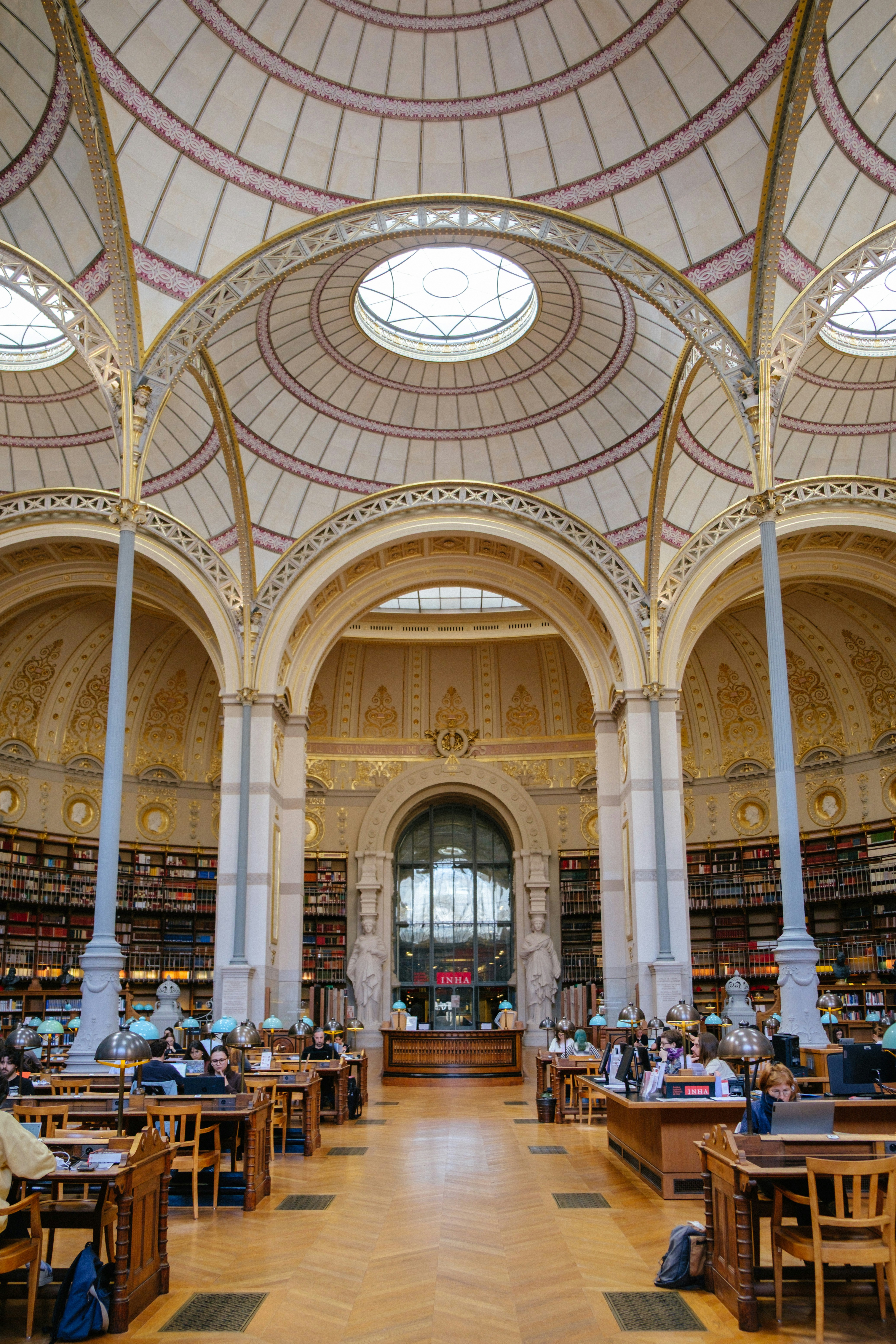 Ornate domed library reading room filled with readers - historic libraries
