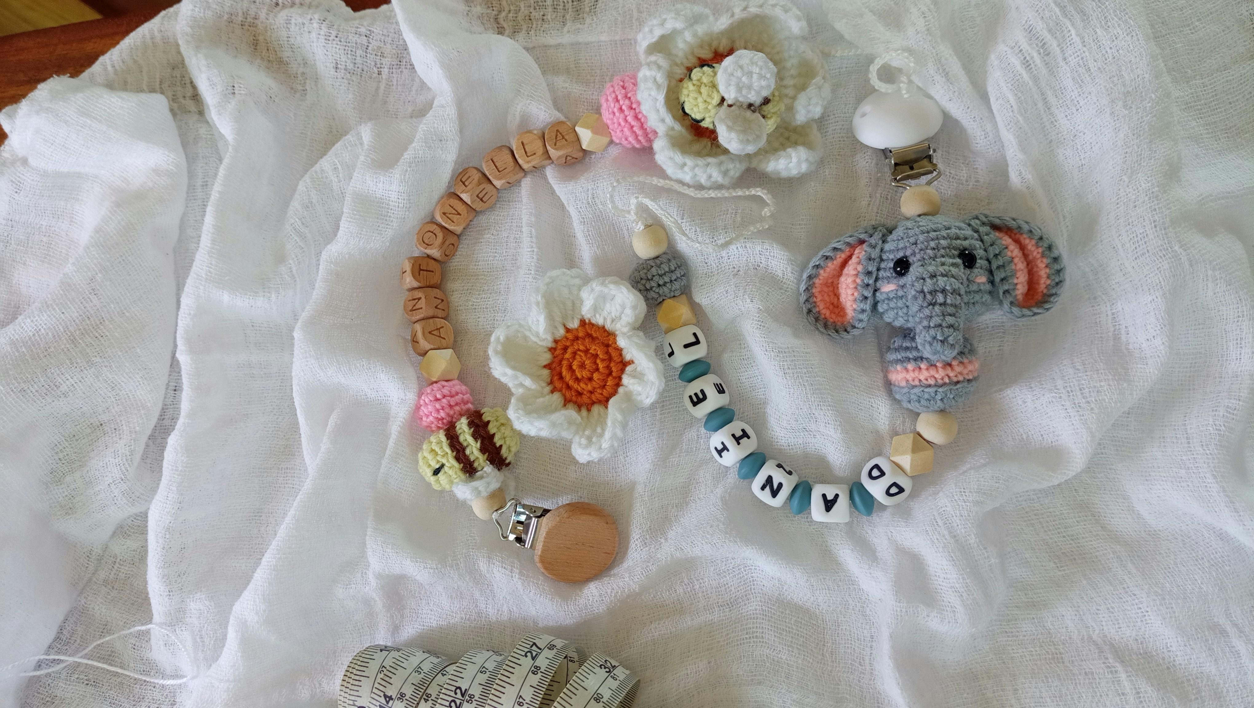 Crocheted baby pacifier clip with elephant, flowers, and beads.