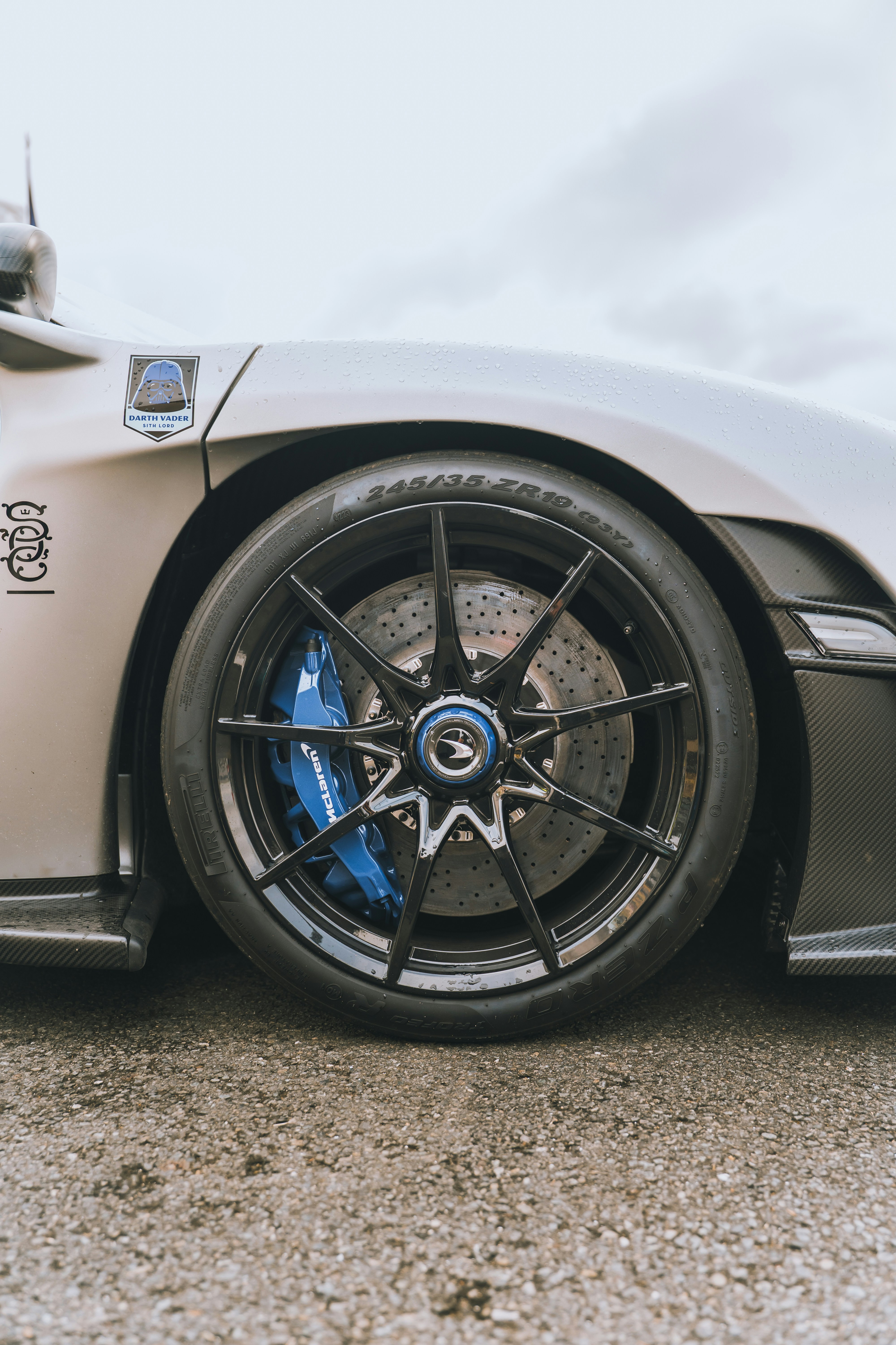 Sportscar wheel with blue brake calipers.