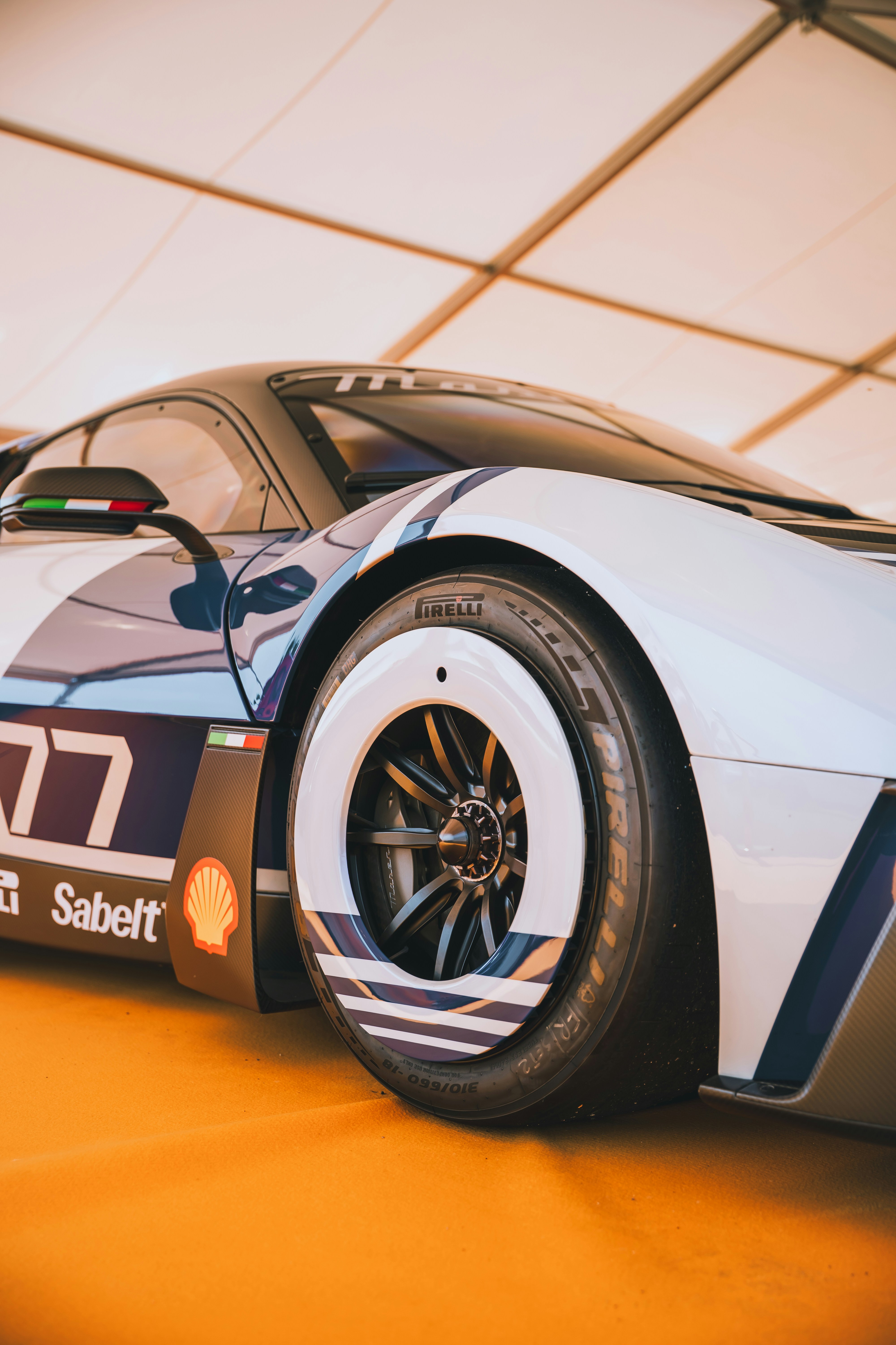 A white and blue race car with "77" branding.