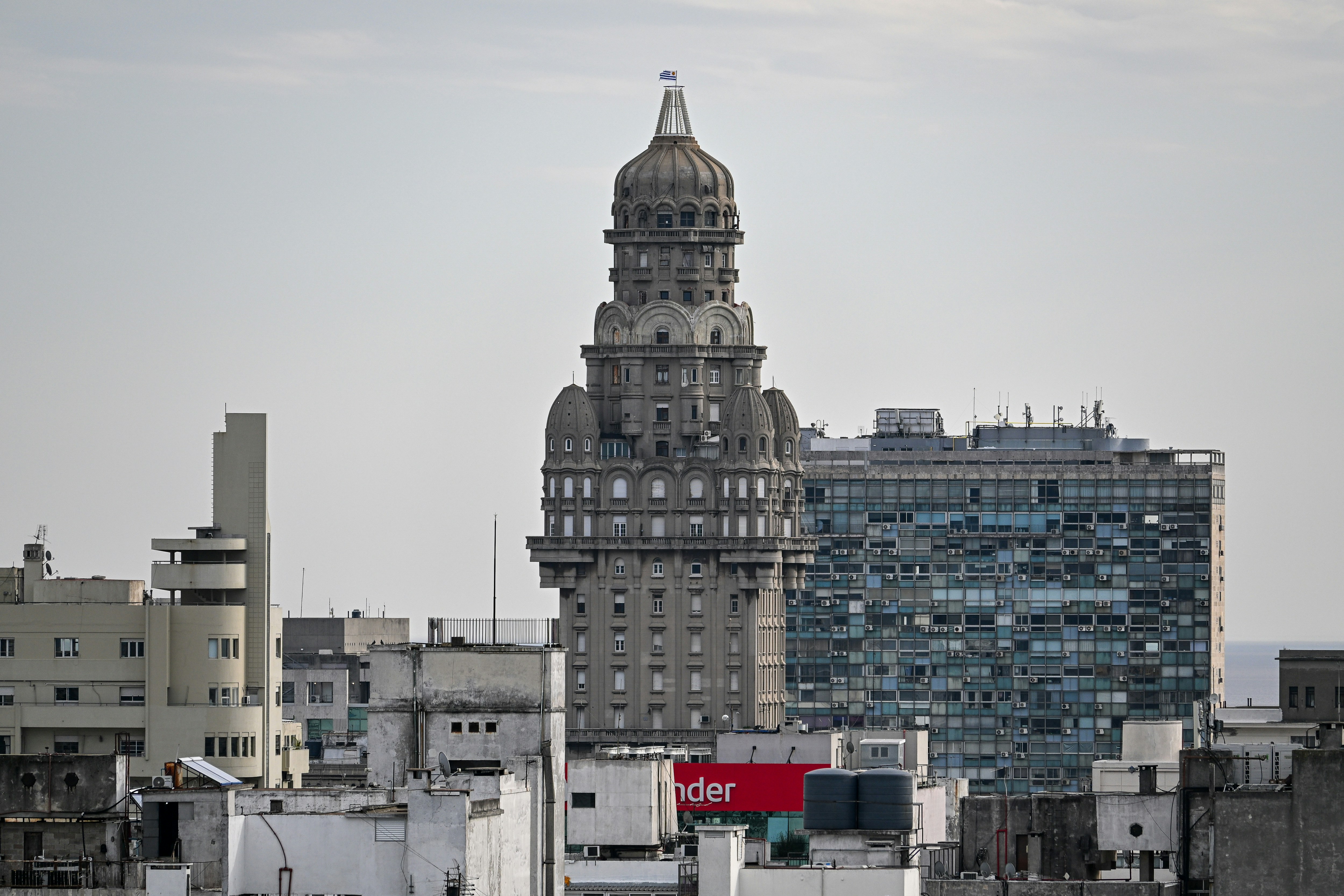 Ornate historic building with a dome in a modern city.
