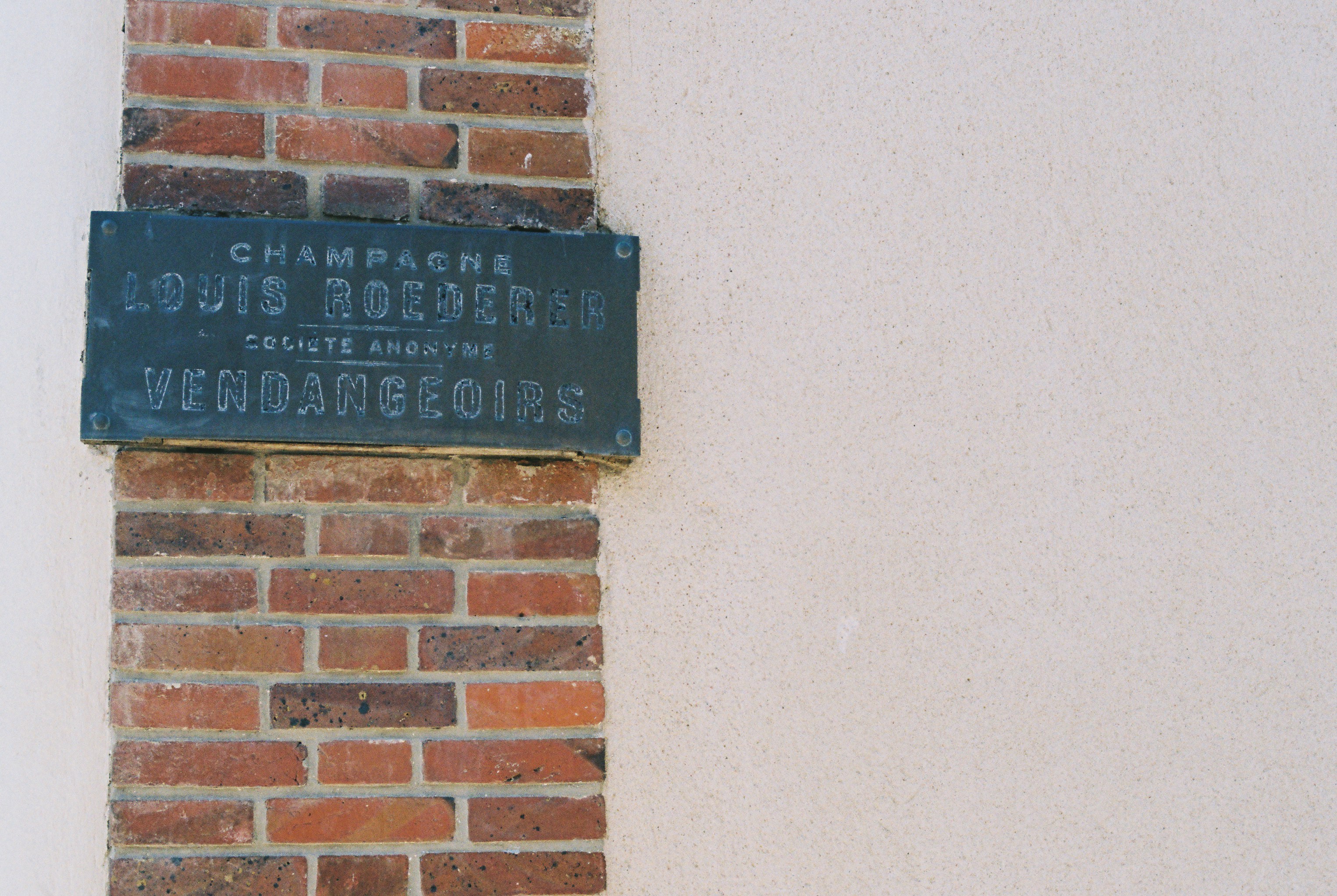 Champagne louis roederer plaque on brick column