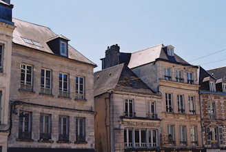 Row of historic stone buildings under clear sky
