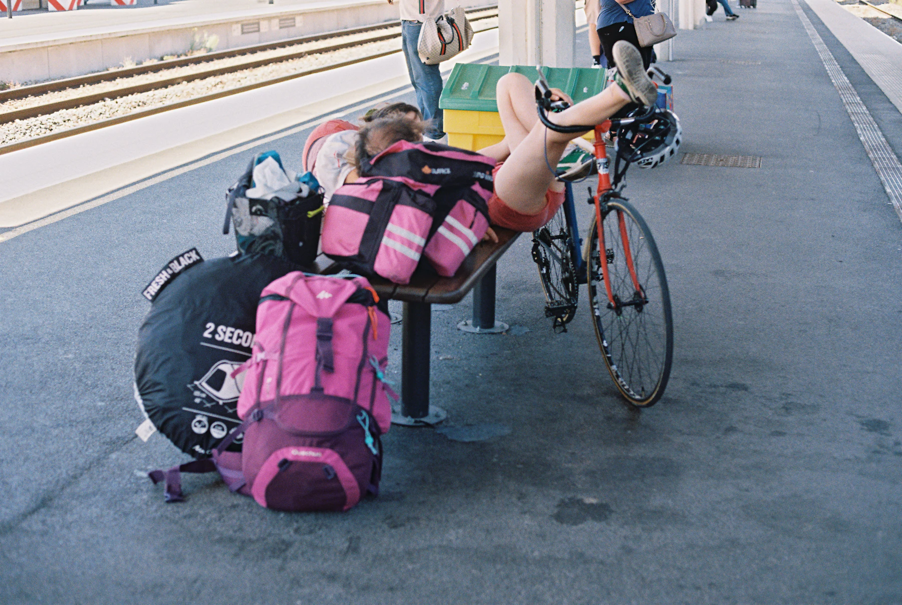 Cyclist resting beside a bicycle and packed riding bags