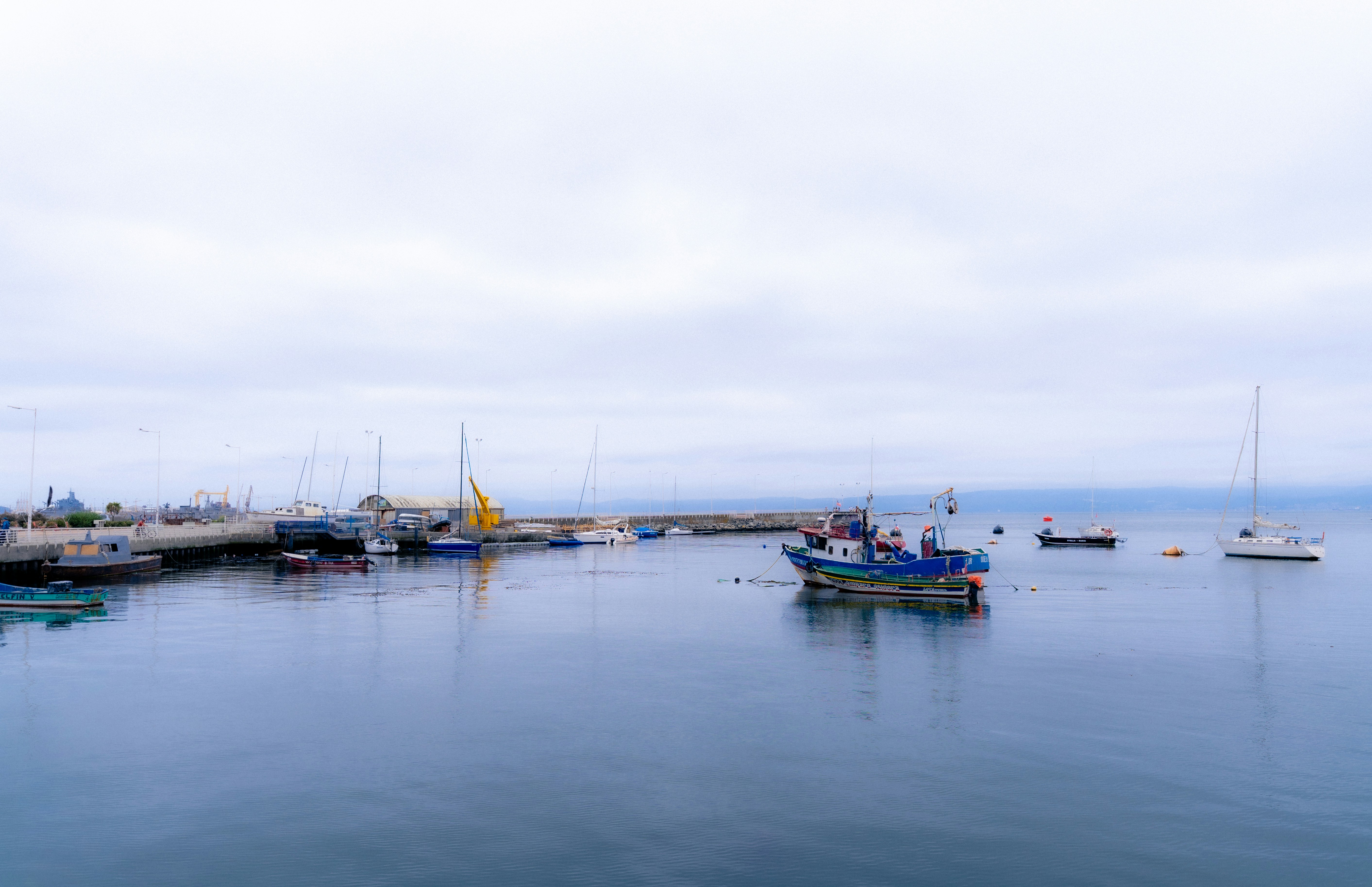 Overcast day at a calm harbor with boats - Free Photo on Unsplash