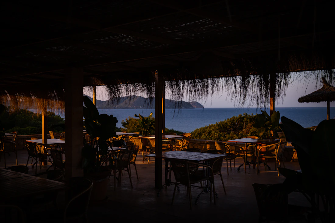 An outdoor dinner table lit at night