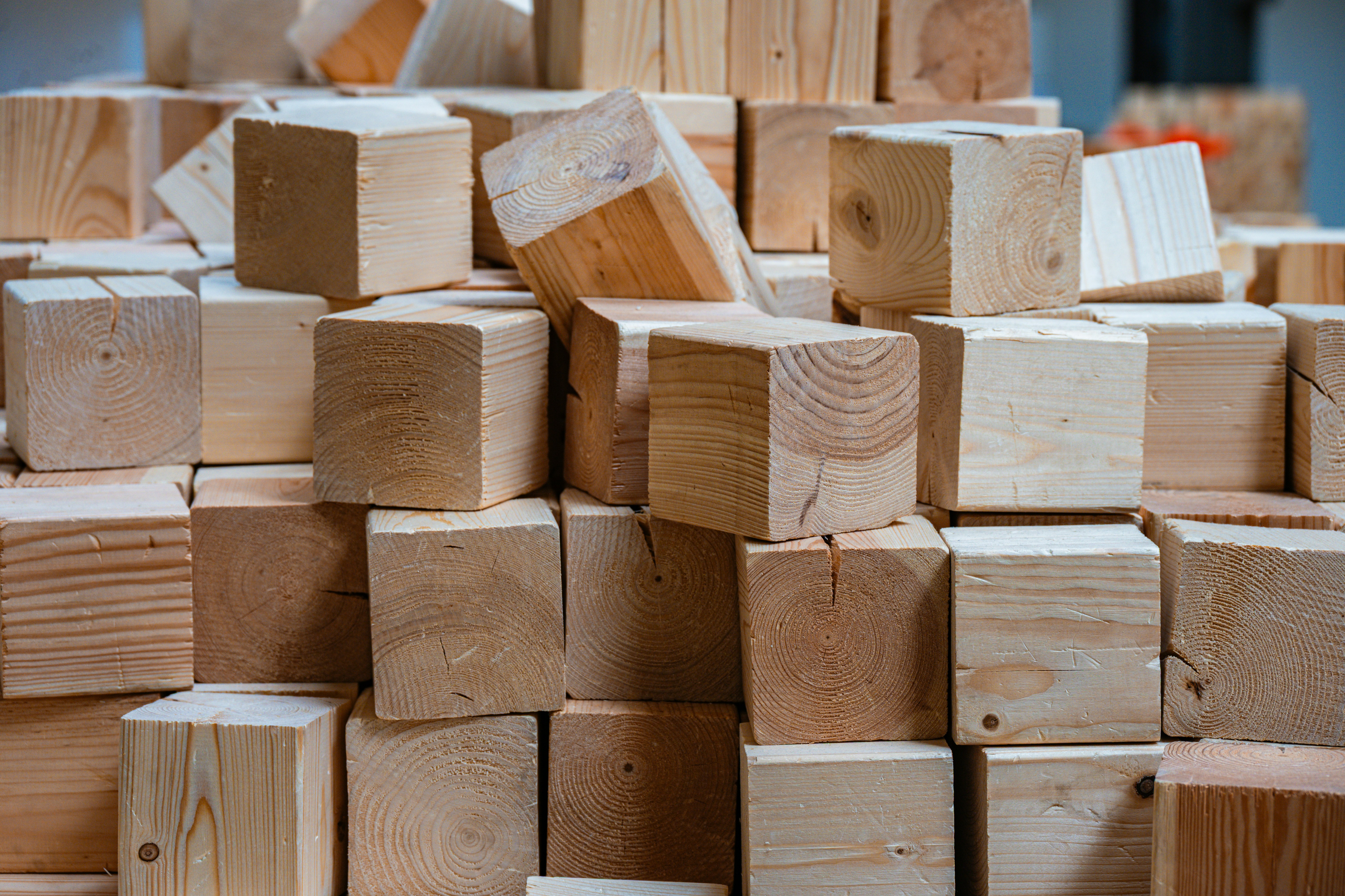 A large pile of natural wooden building blocks