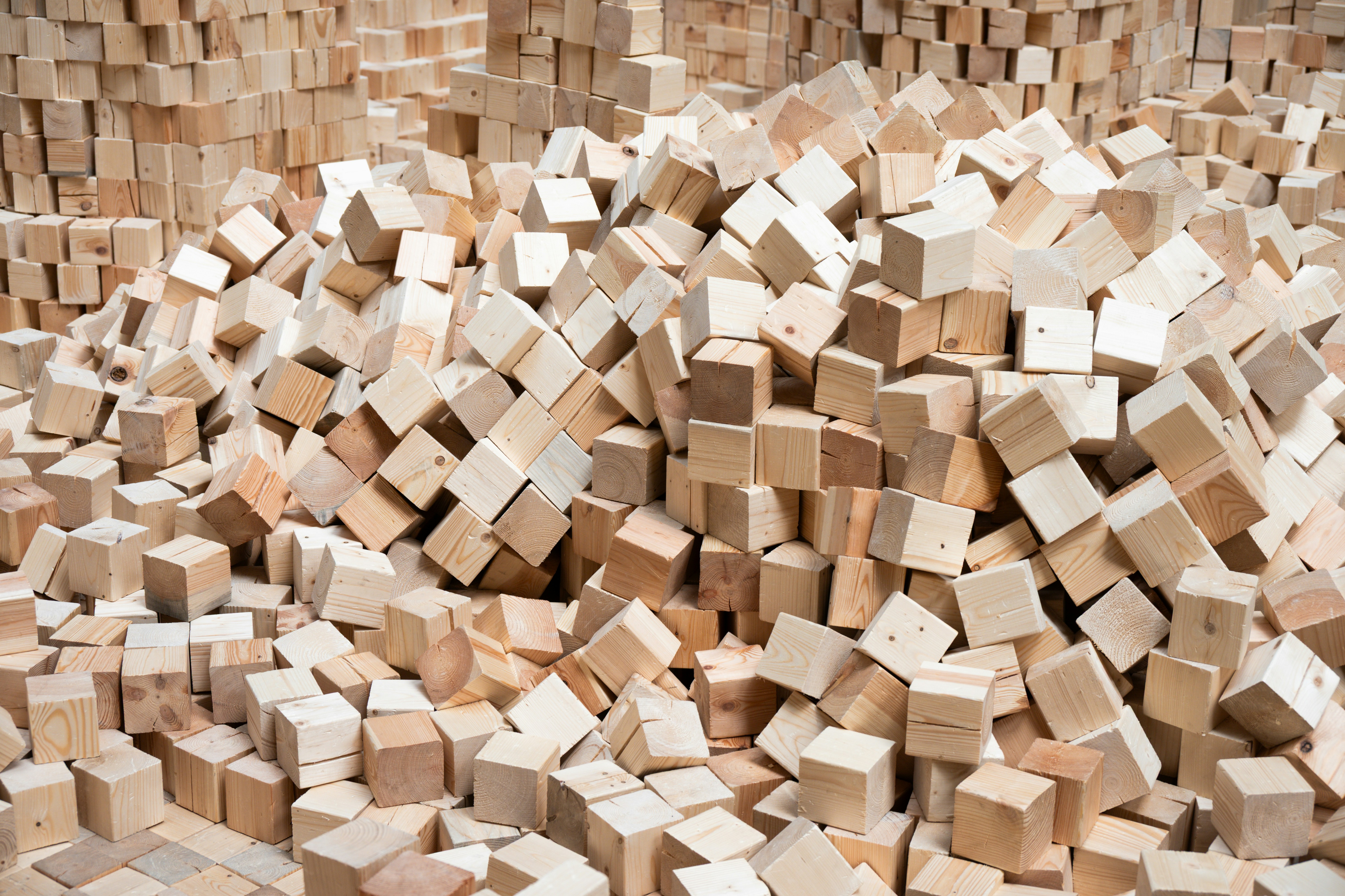 A huge pile of light brown wooden cubes