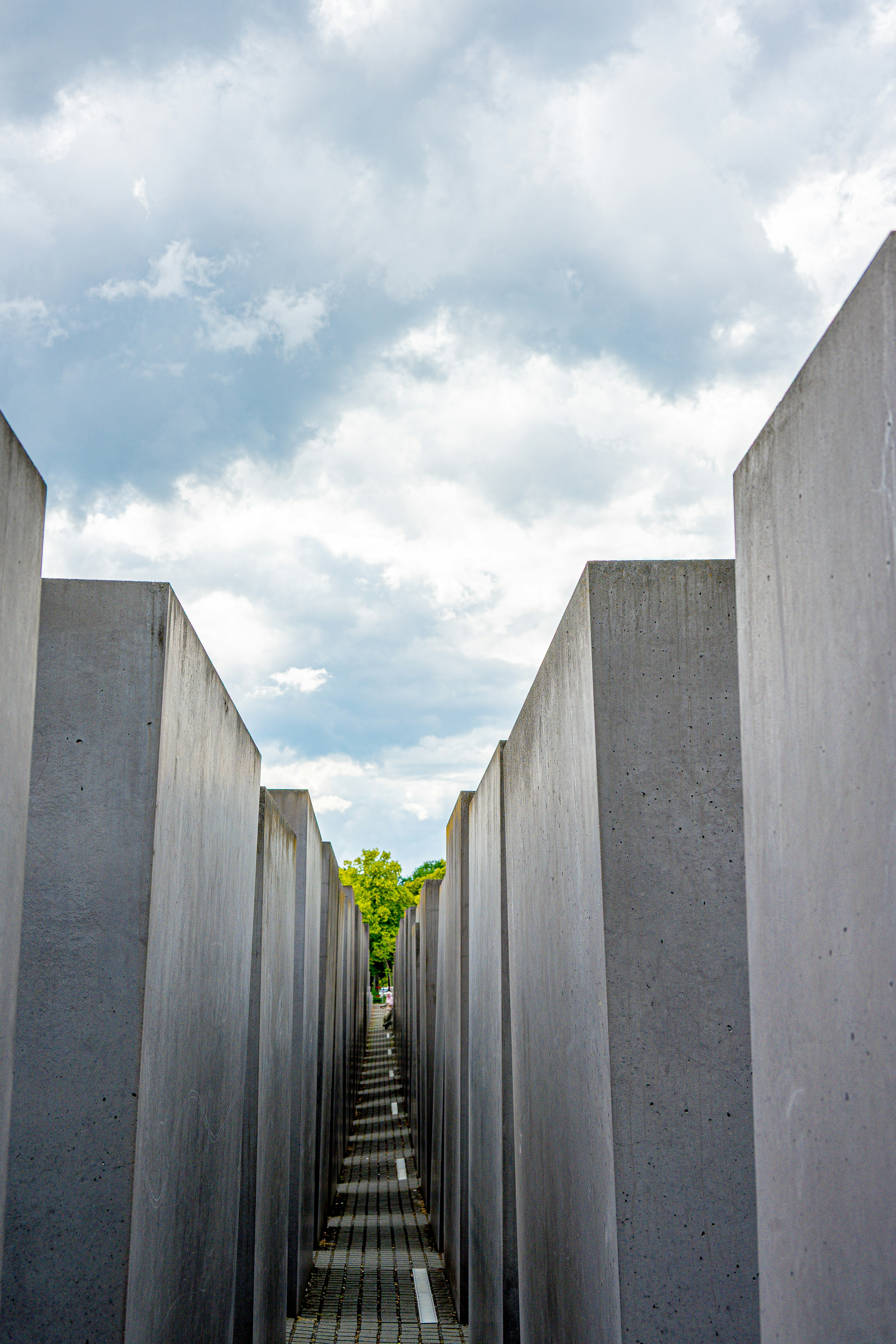 Concrete blocks form a solemn memorial under a cloudy sky