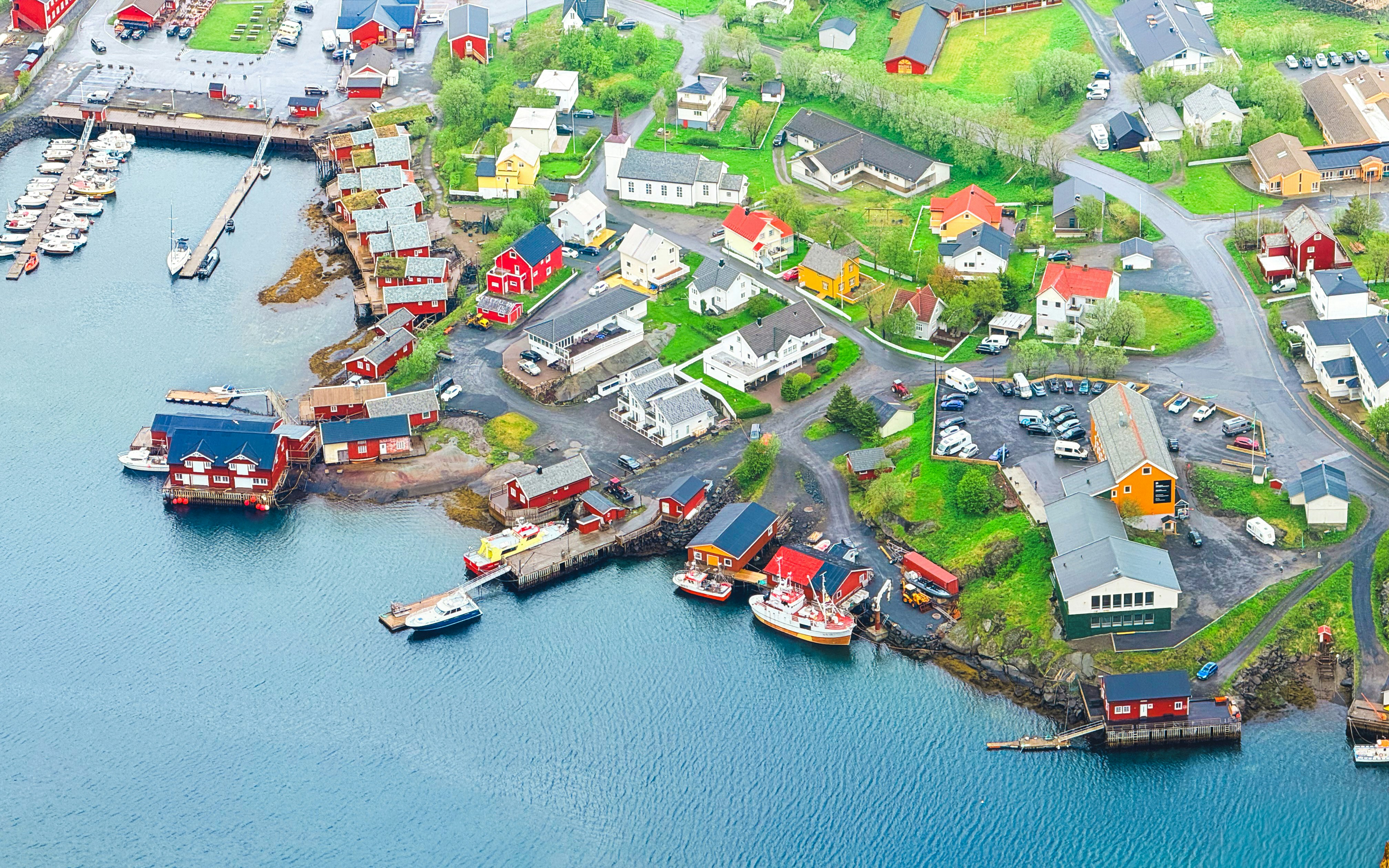 Colorful coastal village with houses and boats along the water