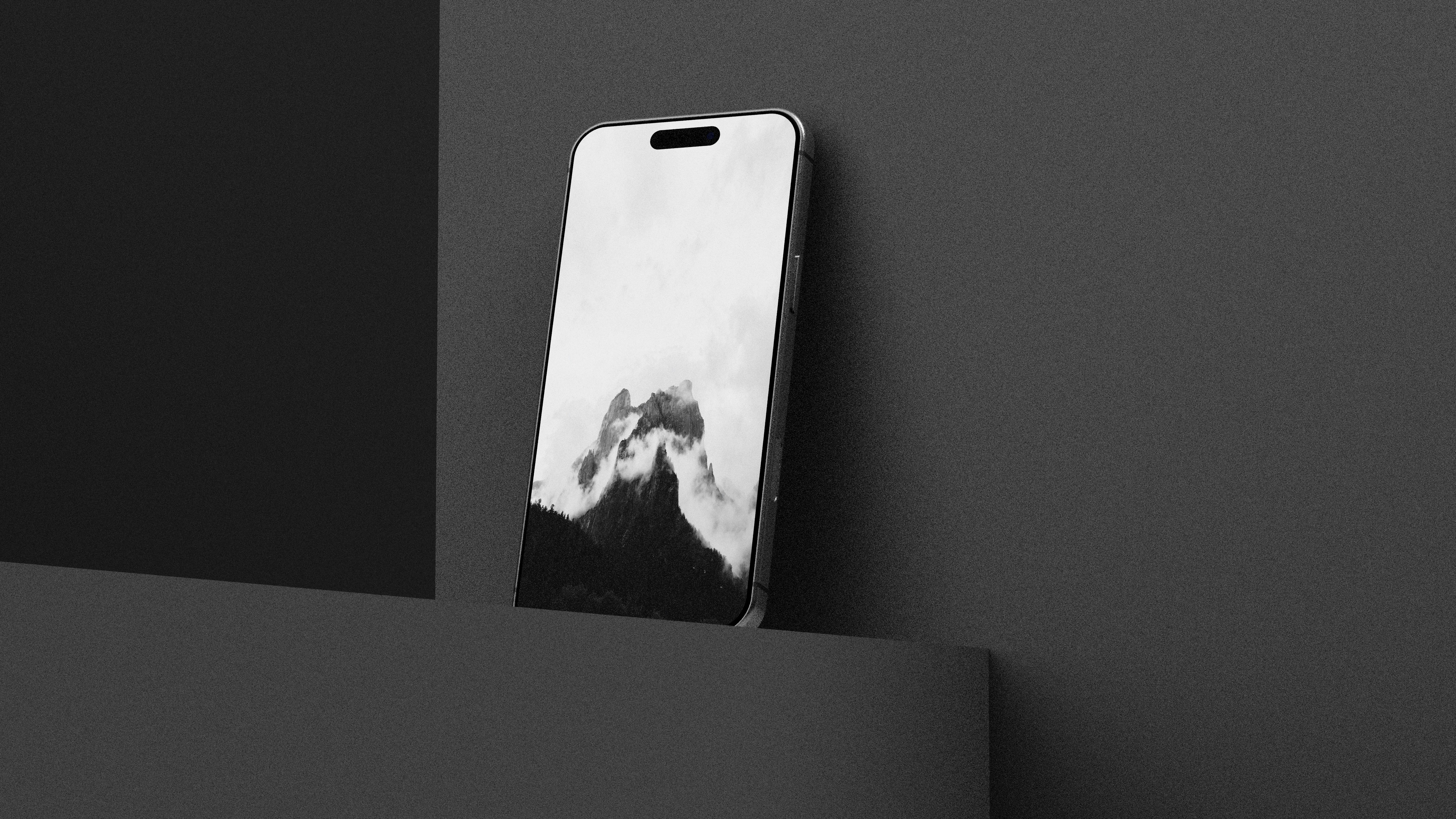 暗い灰色の背景に抽象的な壁紙が描かれたスマートフォン
