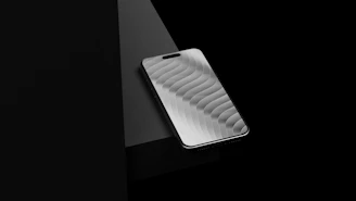 A sleek silver smartphone with a textured screen