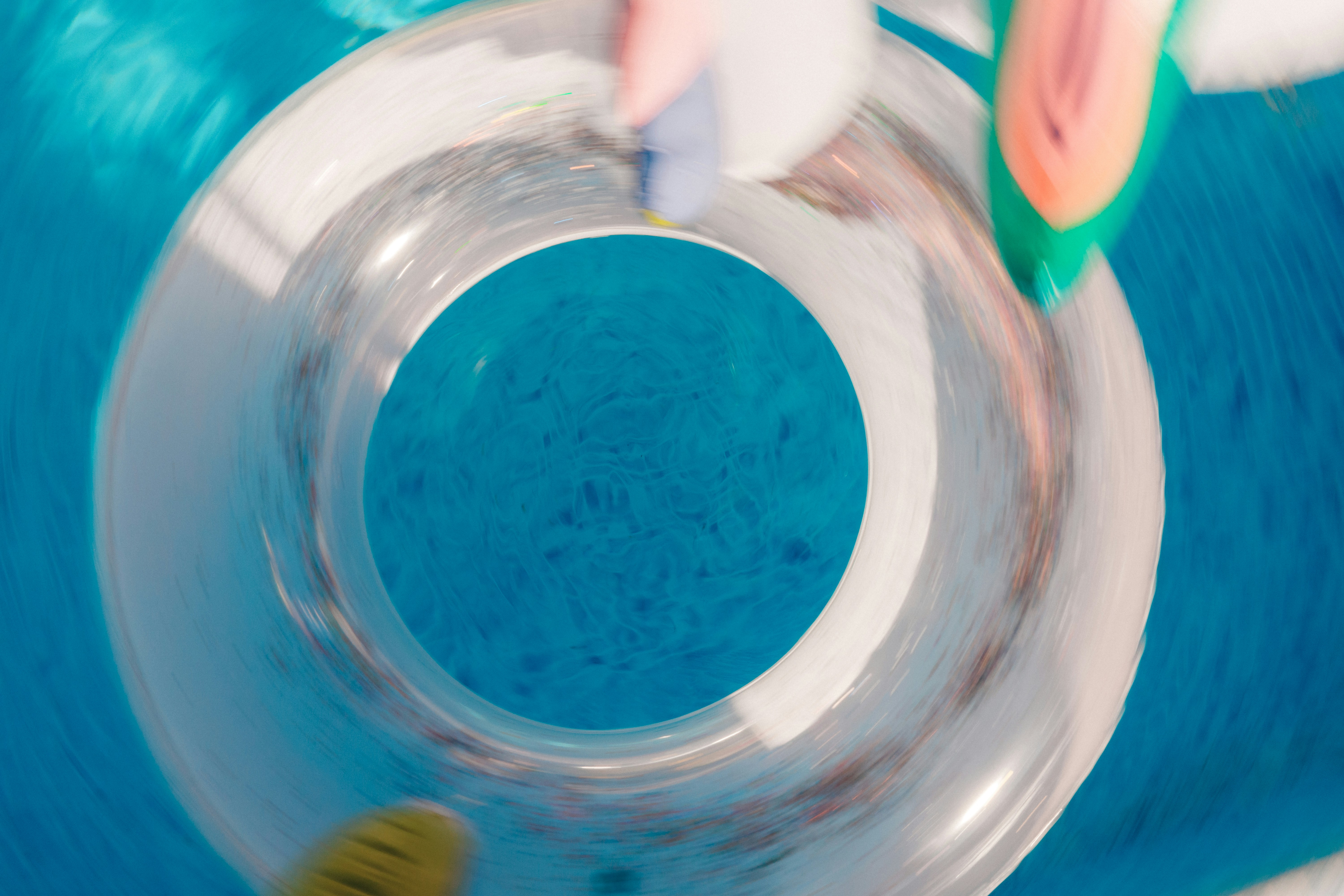 Blue bubbly water swirling down a white toilet.