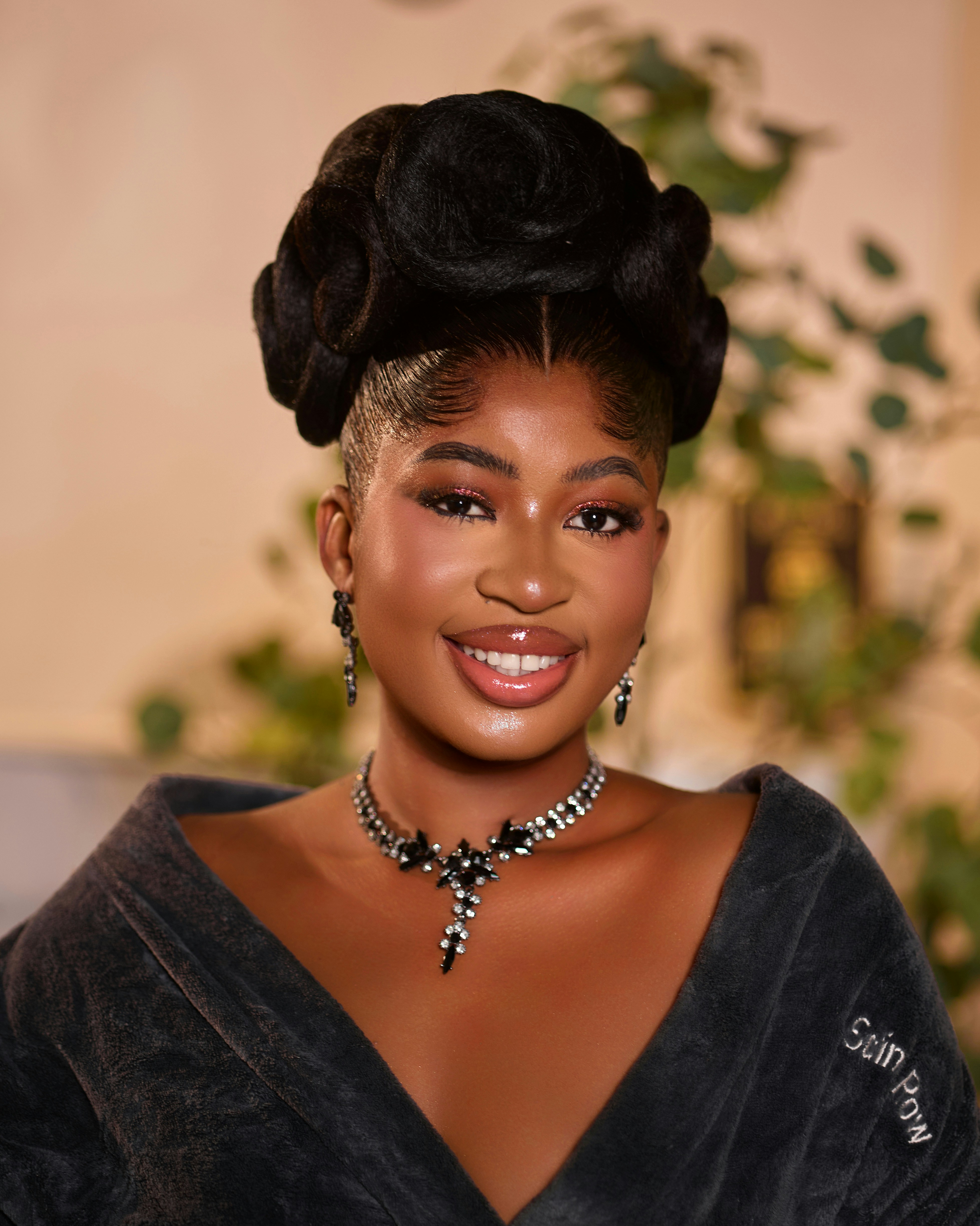 A young woman with an elegant formal hairstyle and sparkling jewellery
