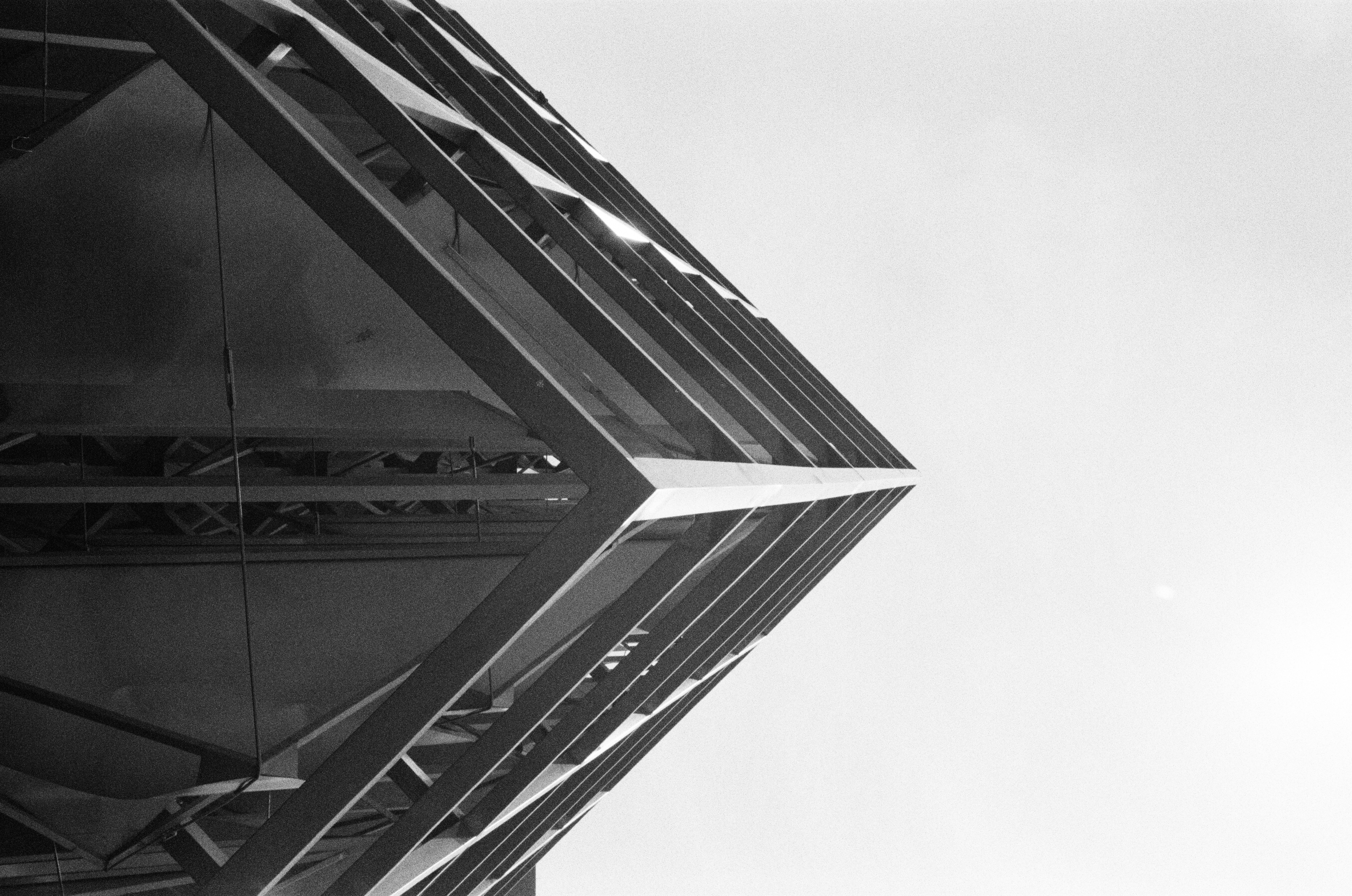Black and white modern building corner against a clear sky.