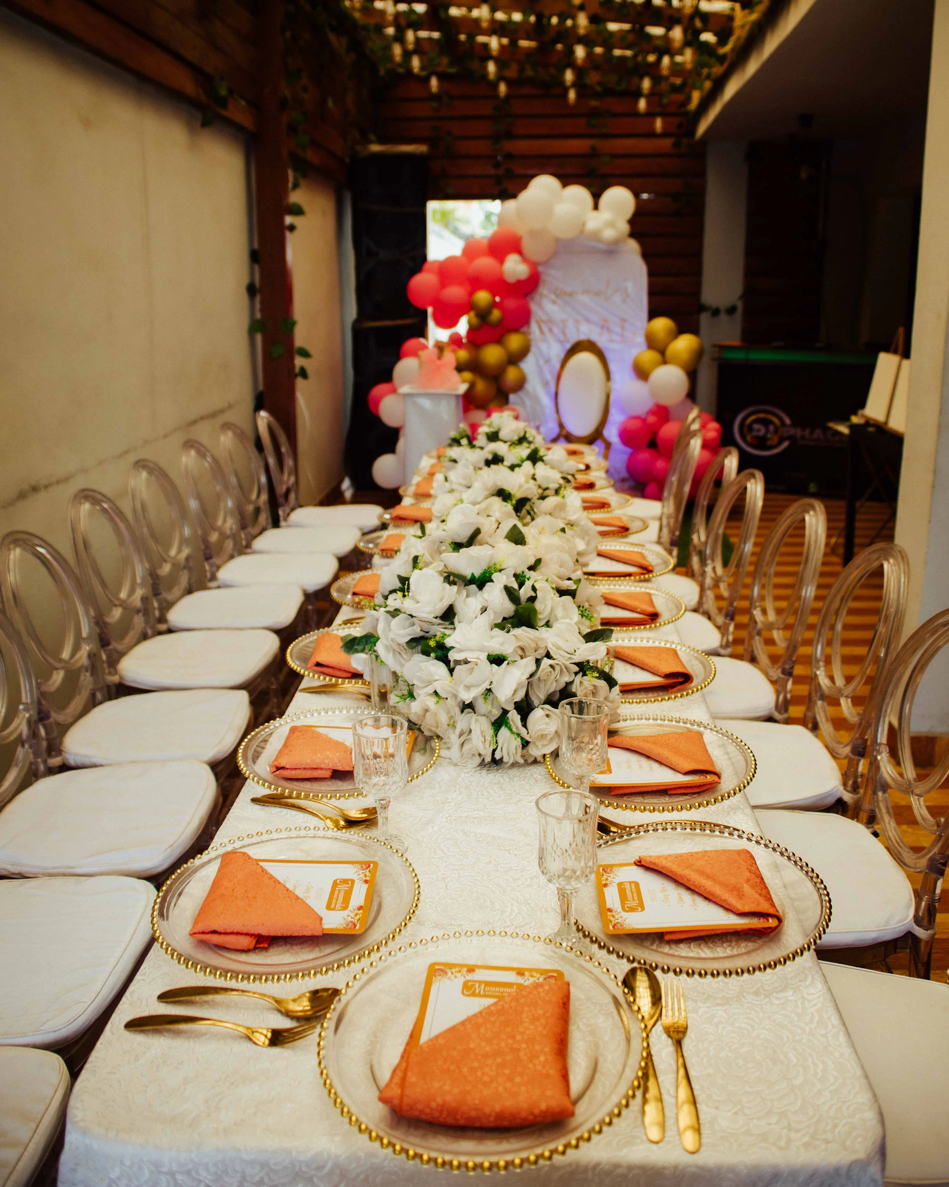 Elegant dining table styled with flowers, napkins and party balloons