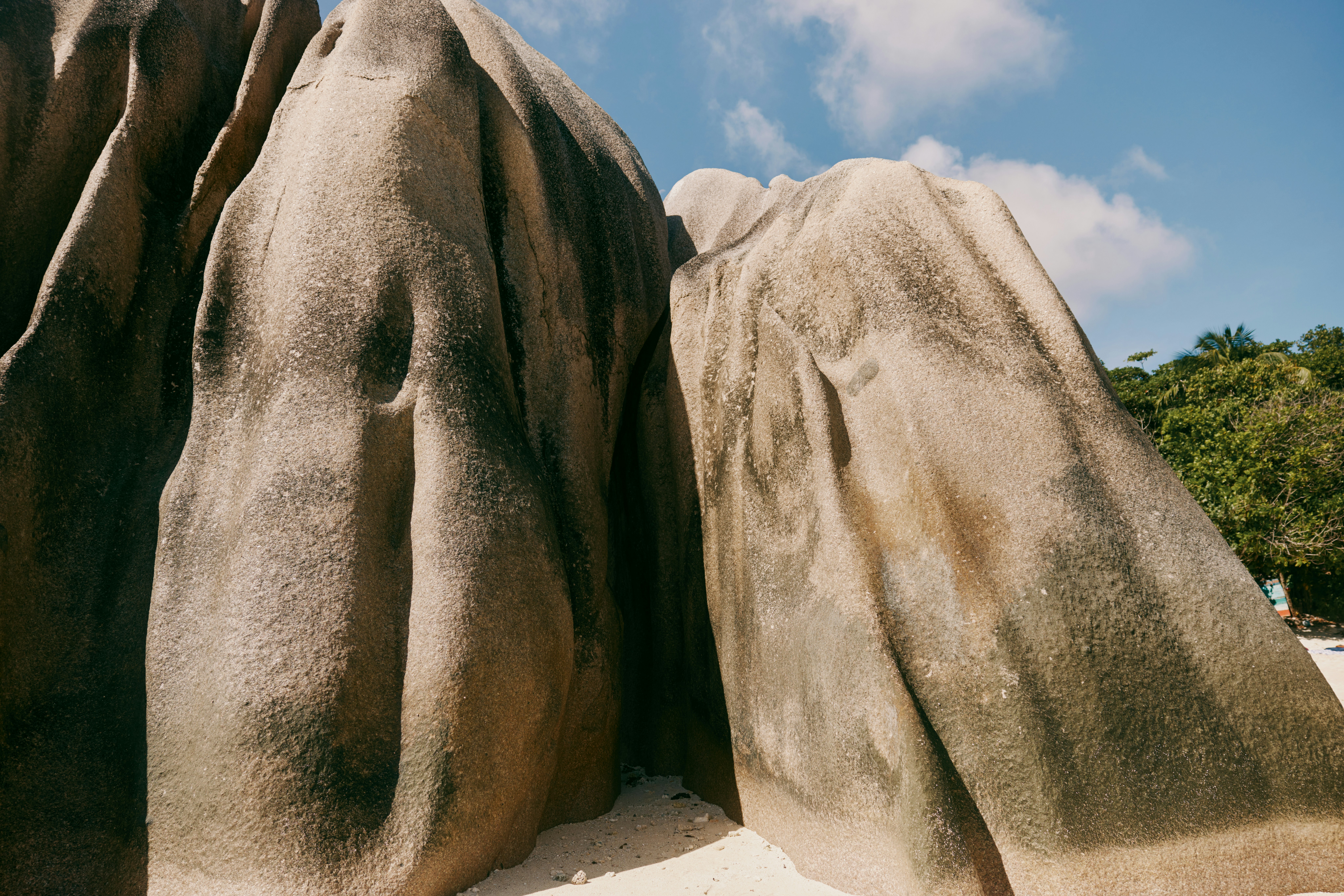 Large granite boulders on a sandy beach