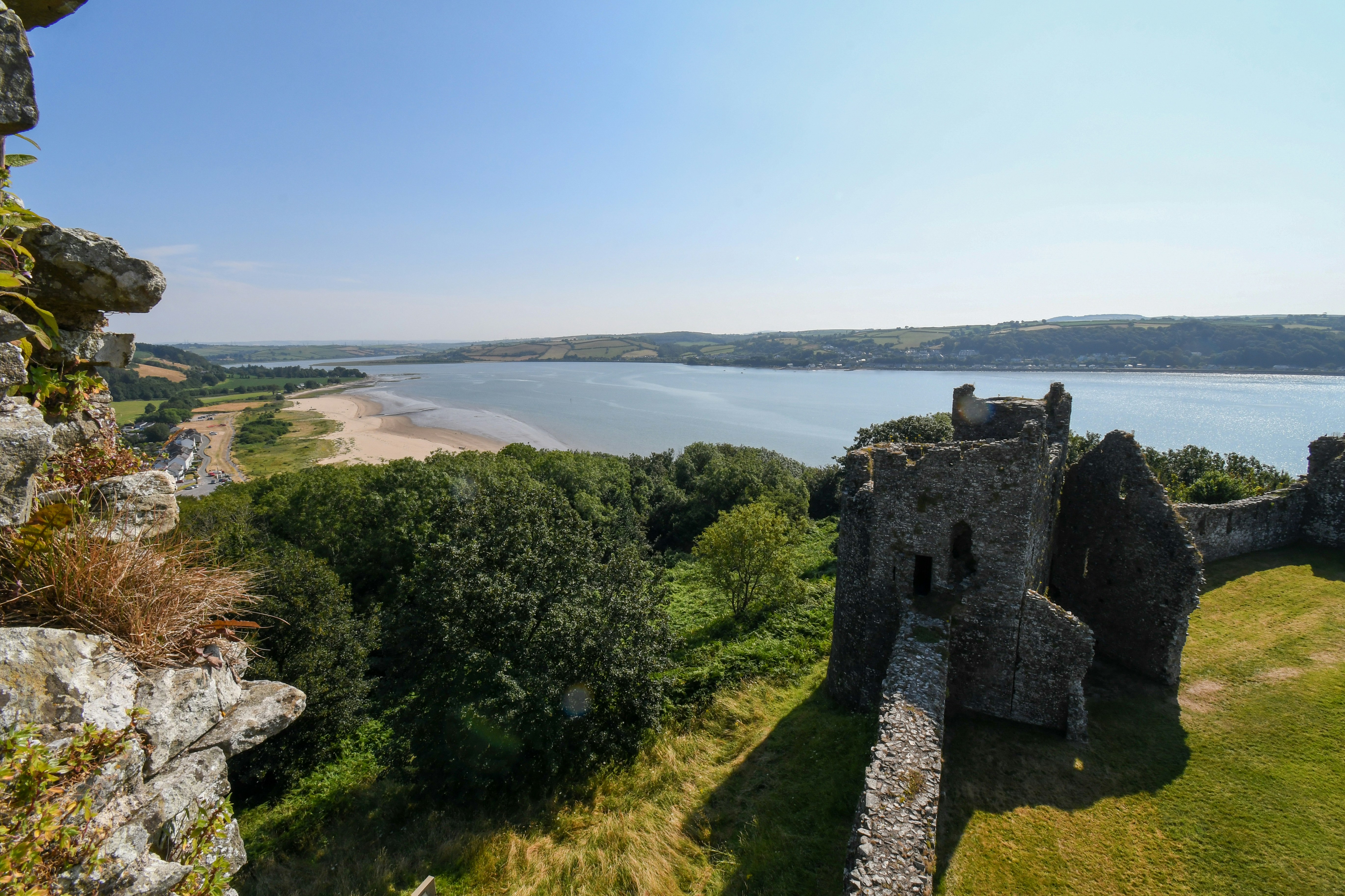 Ancient castle ruins overlooking a beach and calm bay