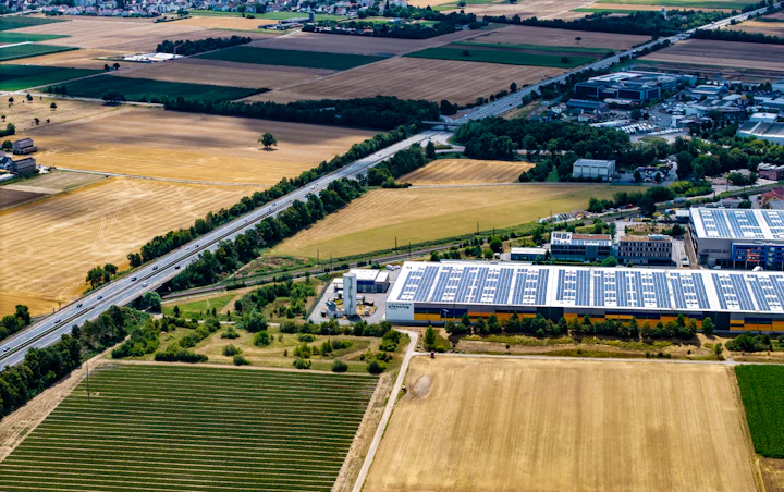 Aerial view of large rooftop solar arrays on industrial buildings