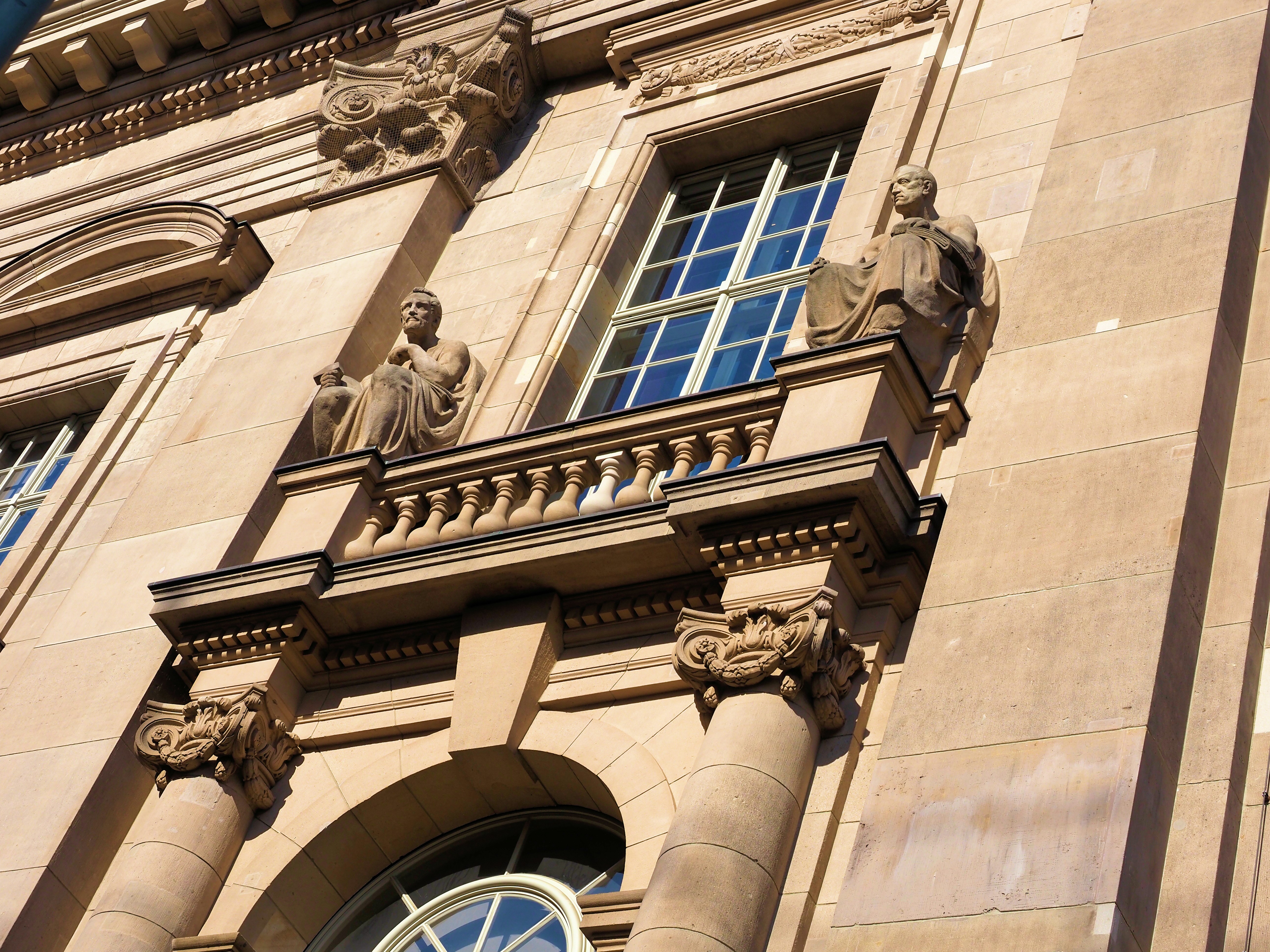 Ornate classical building facade with statues, columns, and windows