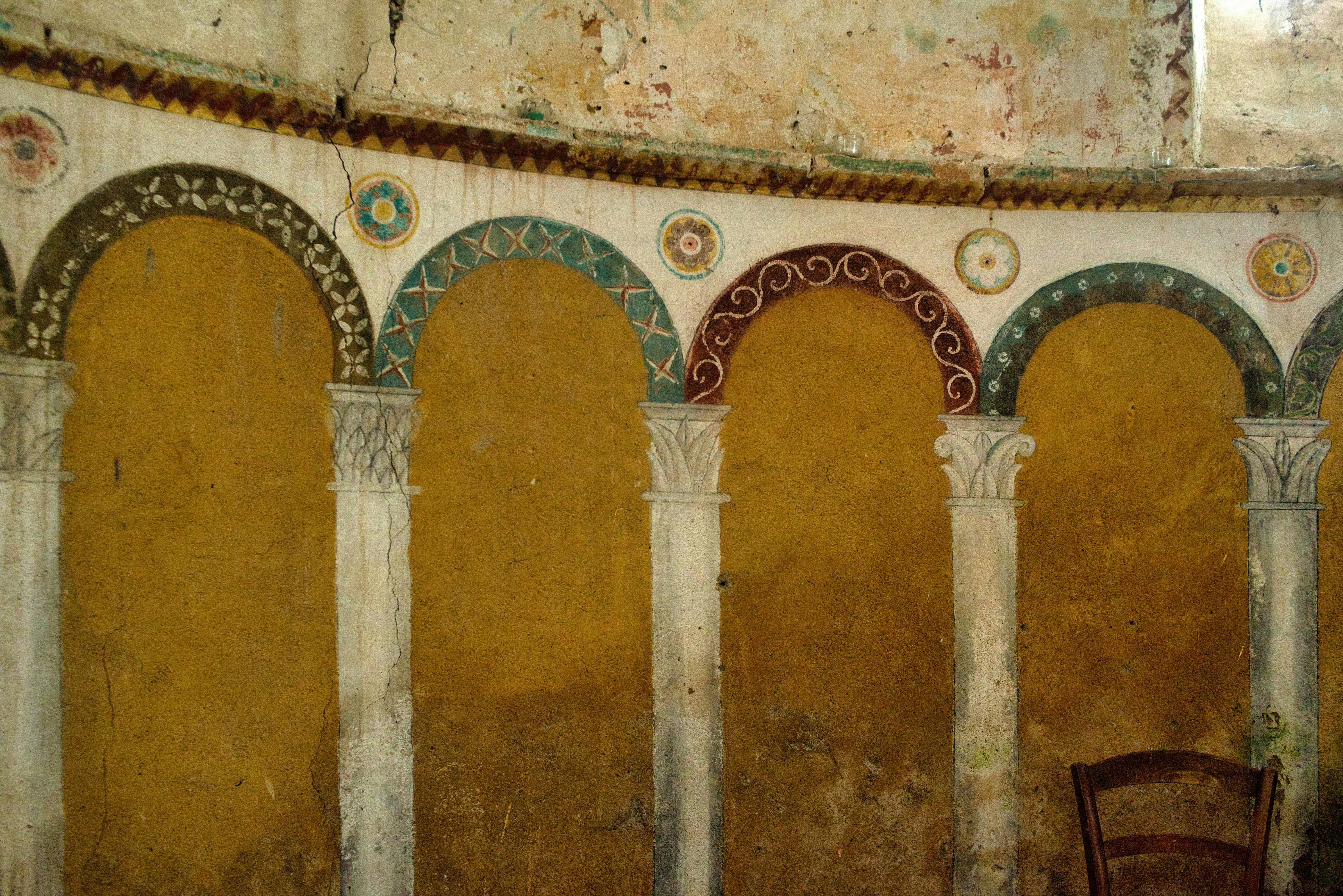 Detailed mosaics adorn ancient arches and columns.