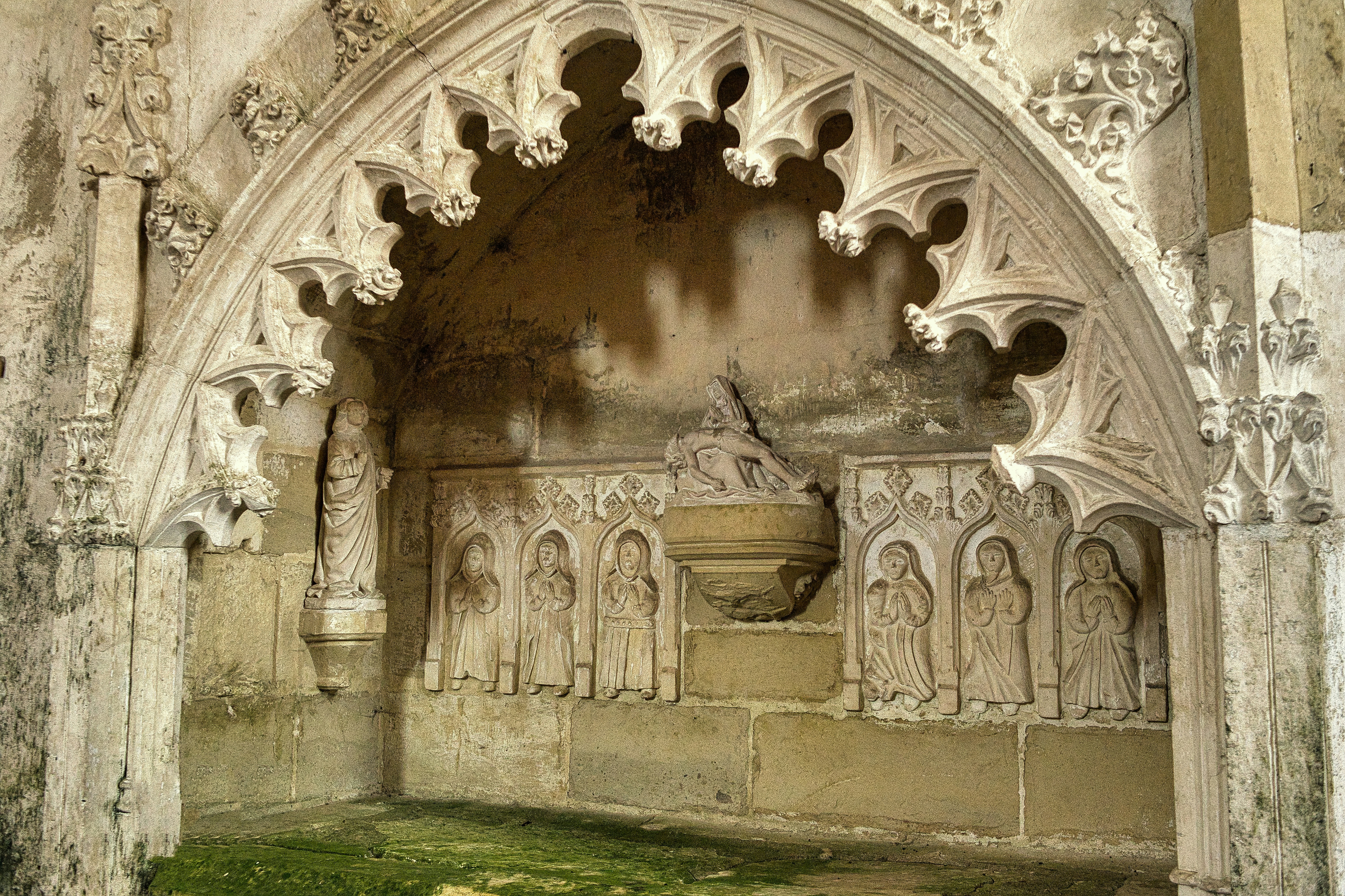 Ornate gothic stone archway with carved figures and weathered details.