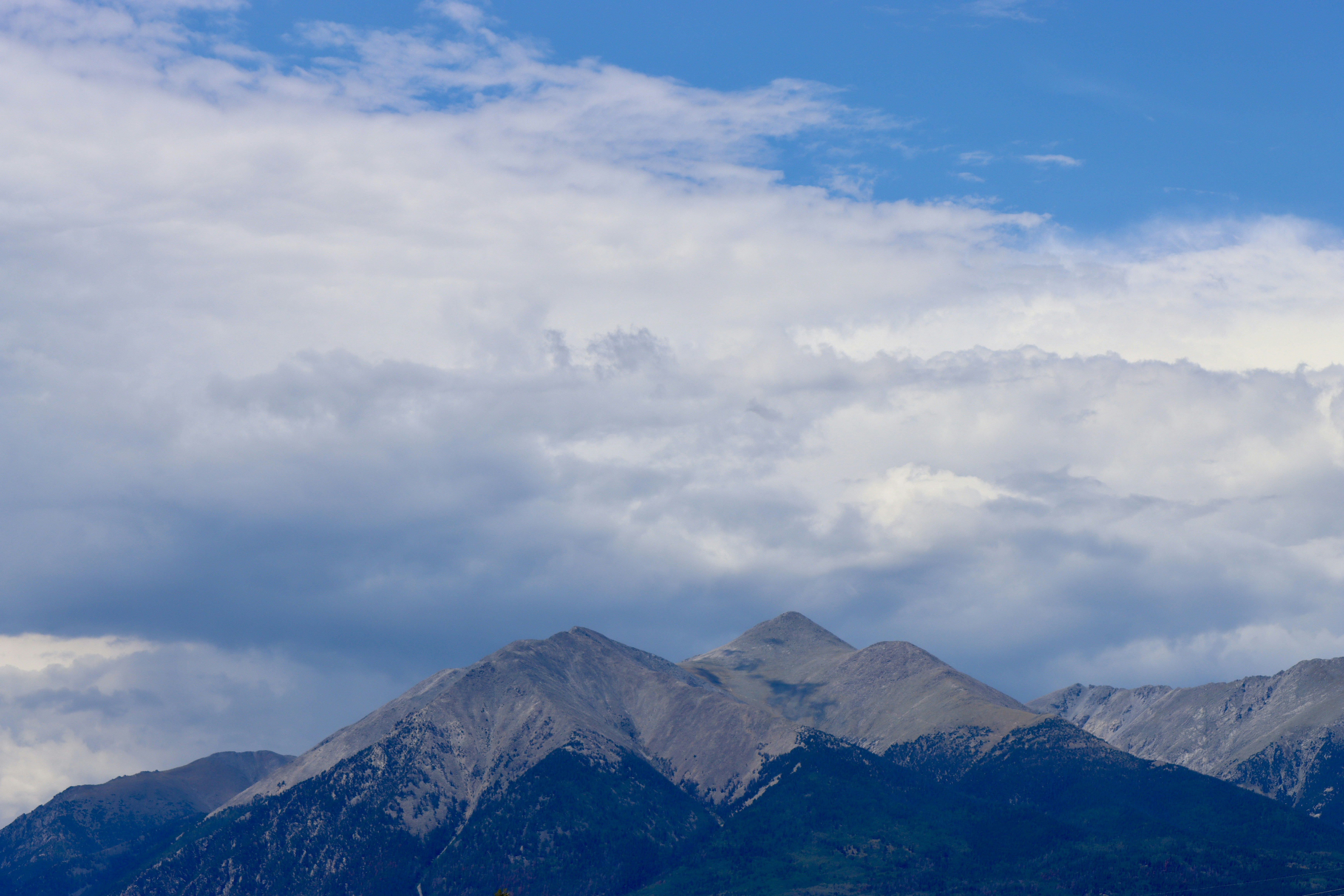 Majestic mountain peaks under a cloudy blue sky