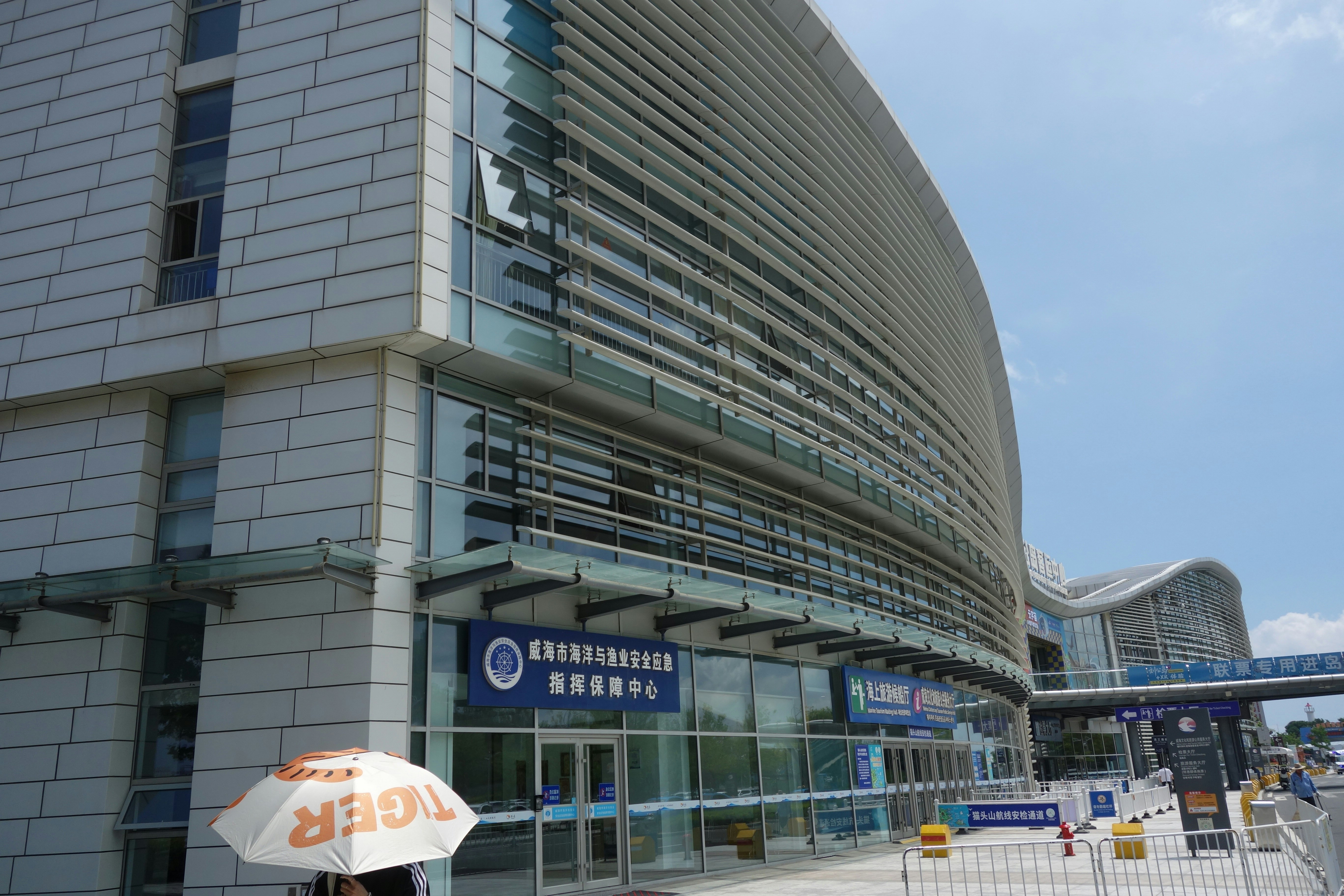Modern building exterior with curved architecture and glass panels.