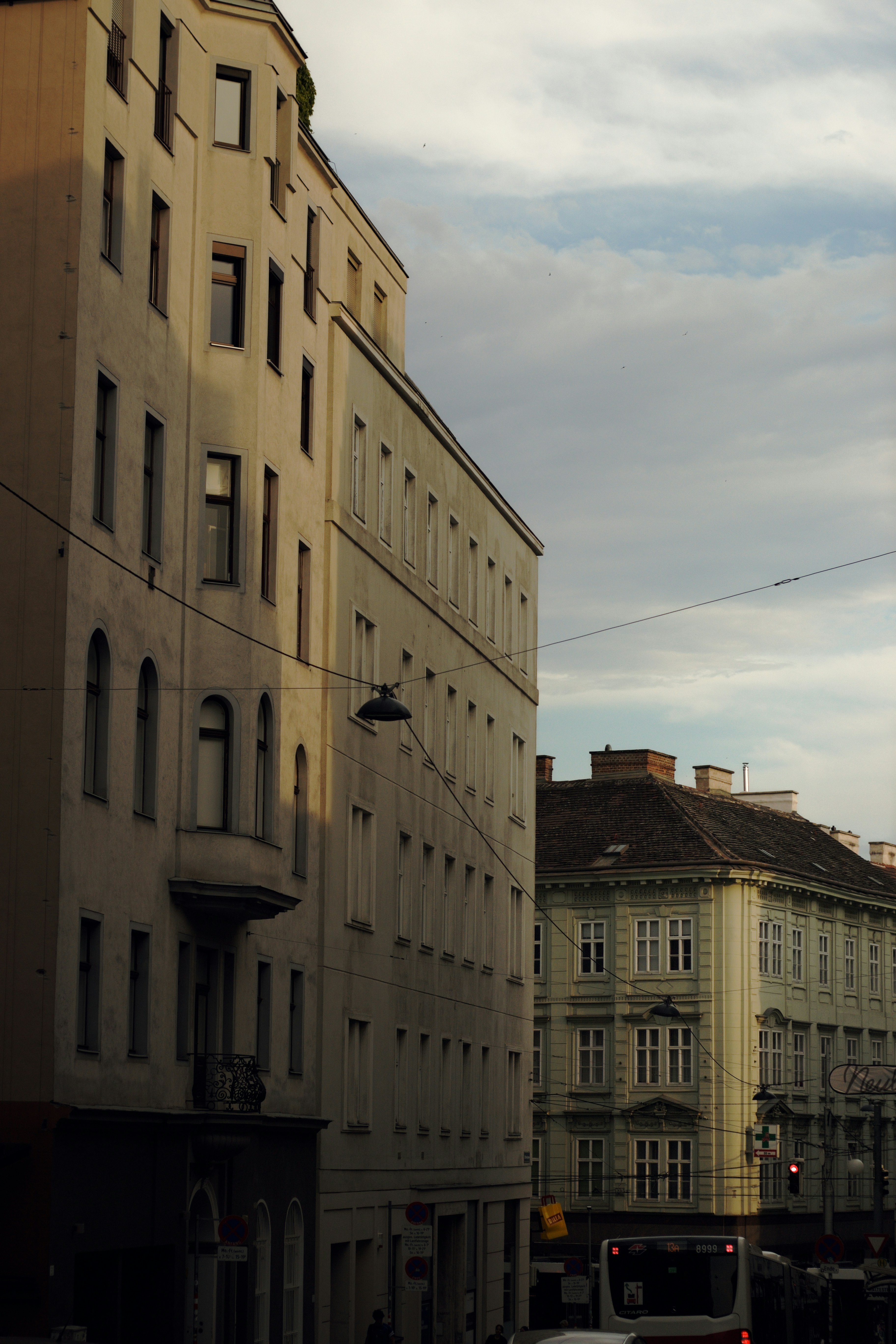 European city street with historic buildings and a bus.